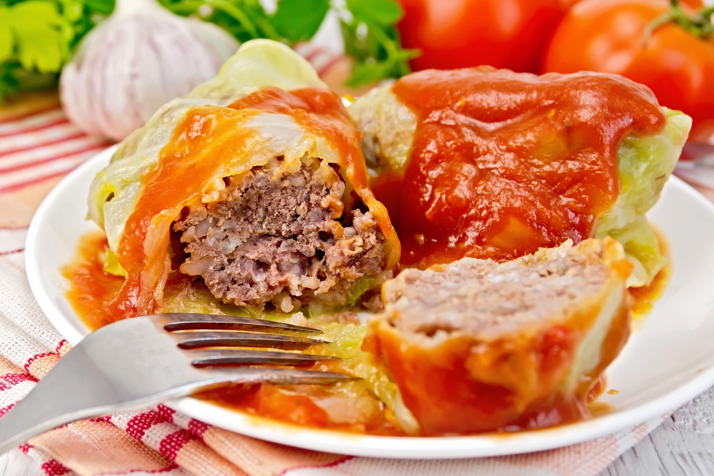 Stuffed Cabbage cut in half on a white plate