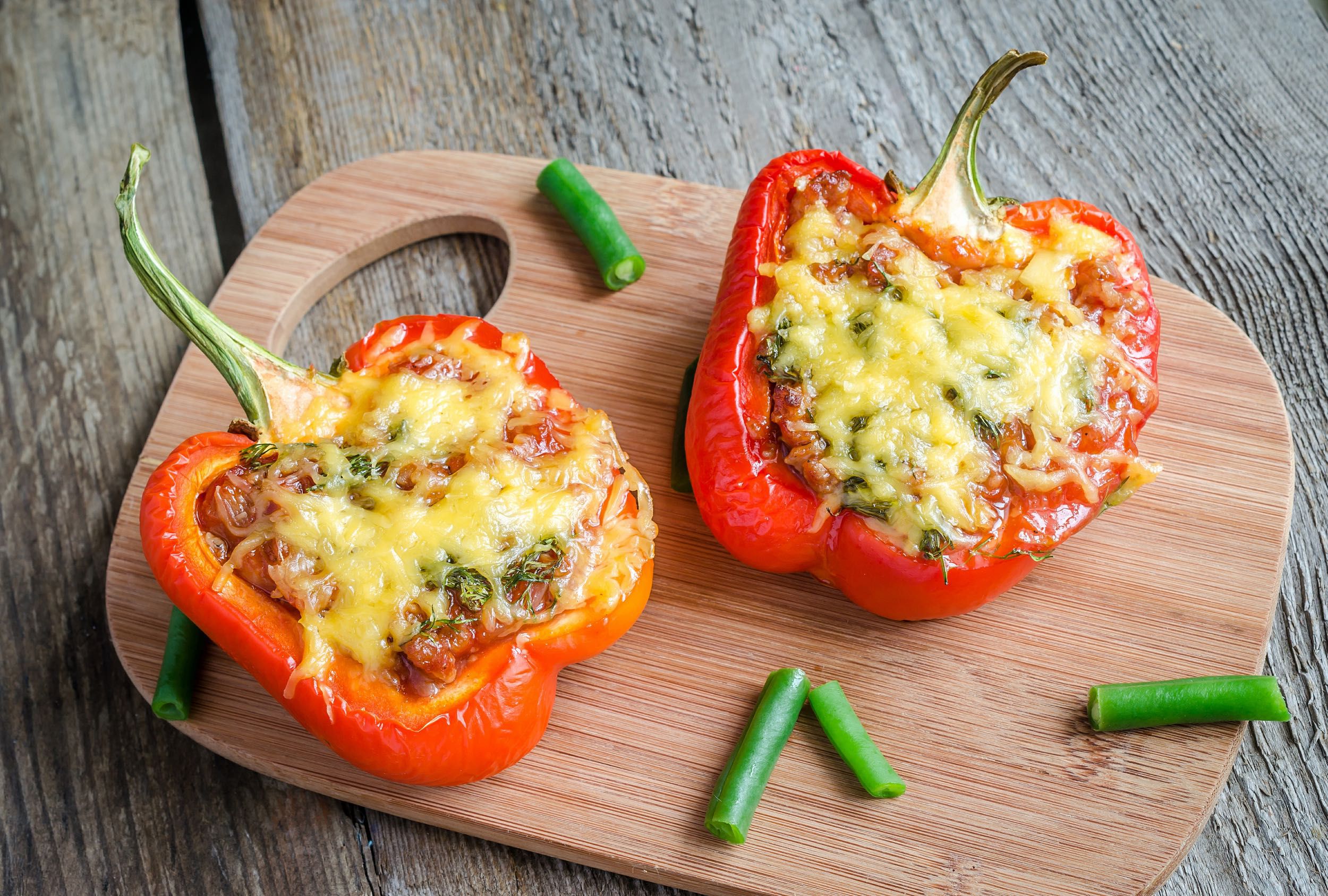 Black Bean Stuffed Pepper cut in half on a wooden cutting board