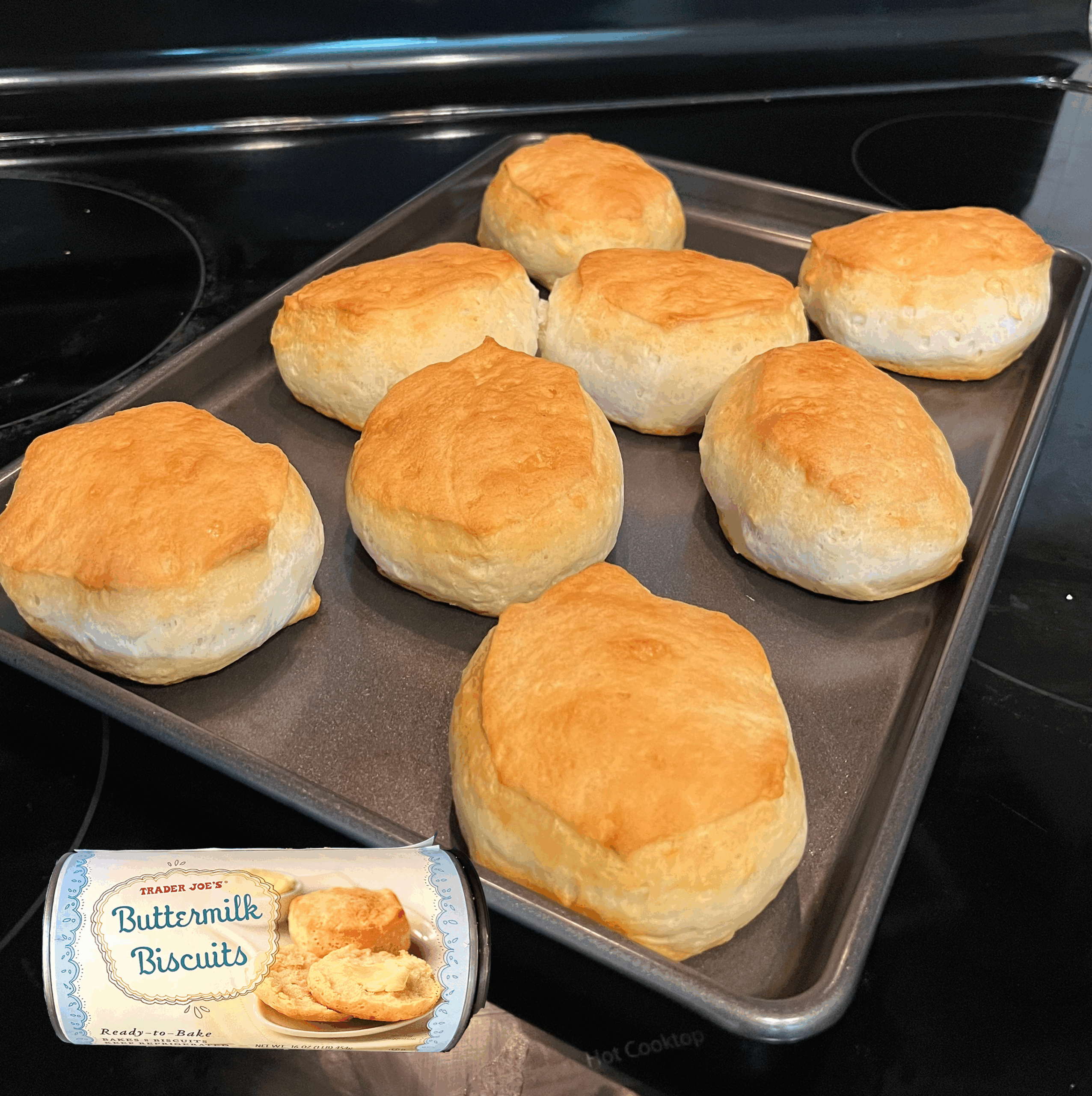 Trader Joe's Buttermilk Biscuits baked on a tray with an overlay of product can