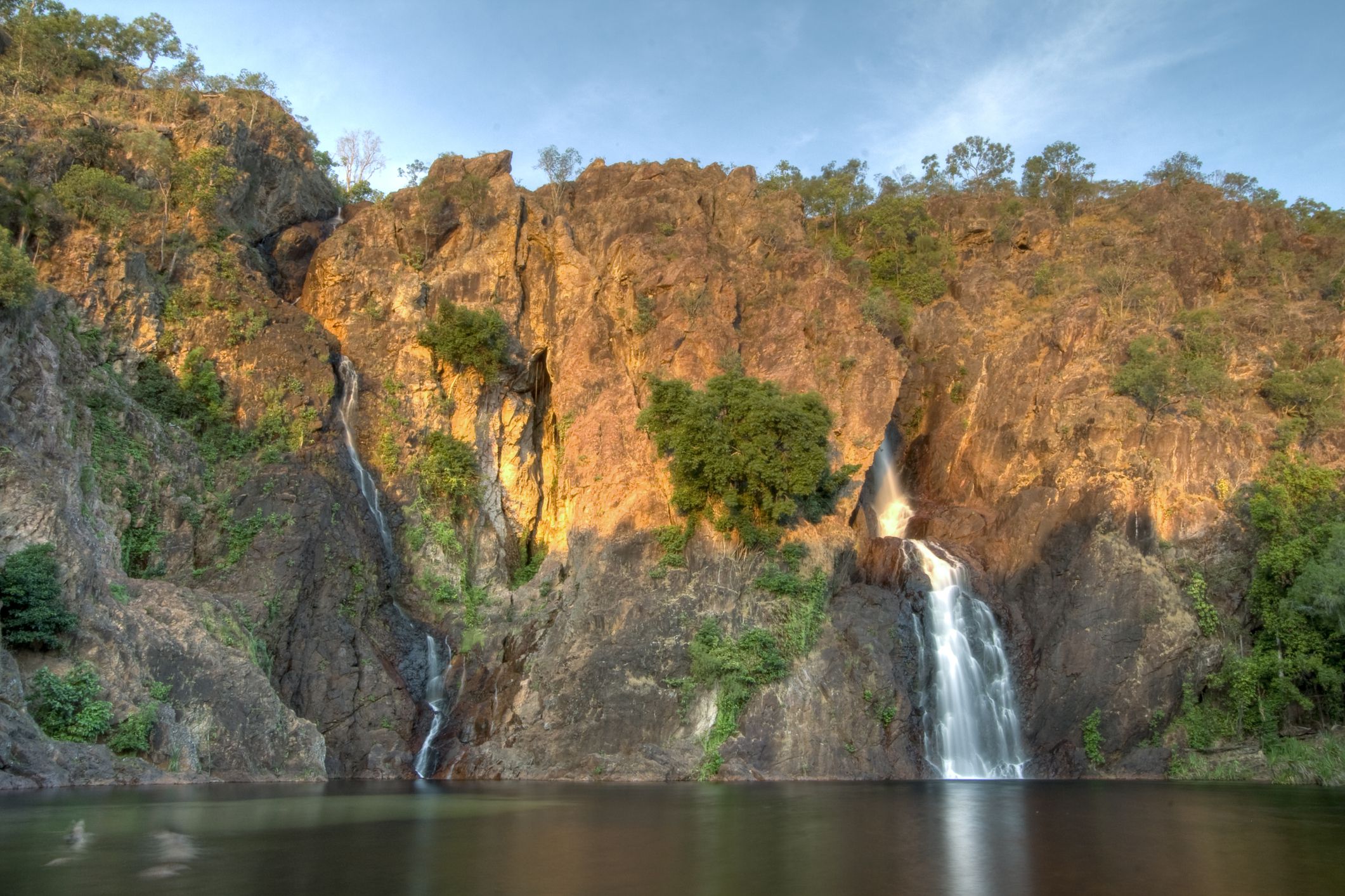 Wangi Falls, Litchfield National Park, Australia with swimming hole while sun setting colors are on the rocks
