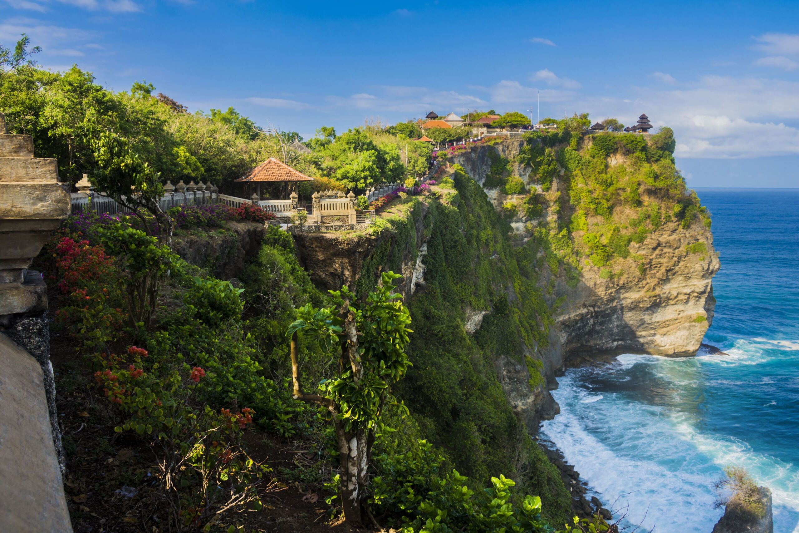 uluwatu temple perched on top of a cliff in bali, indonesia