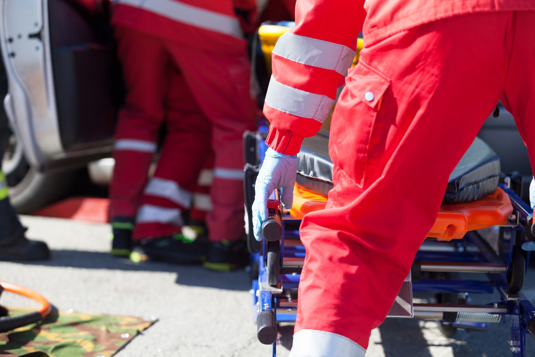 paramedics wheeling stretcher into van