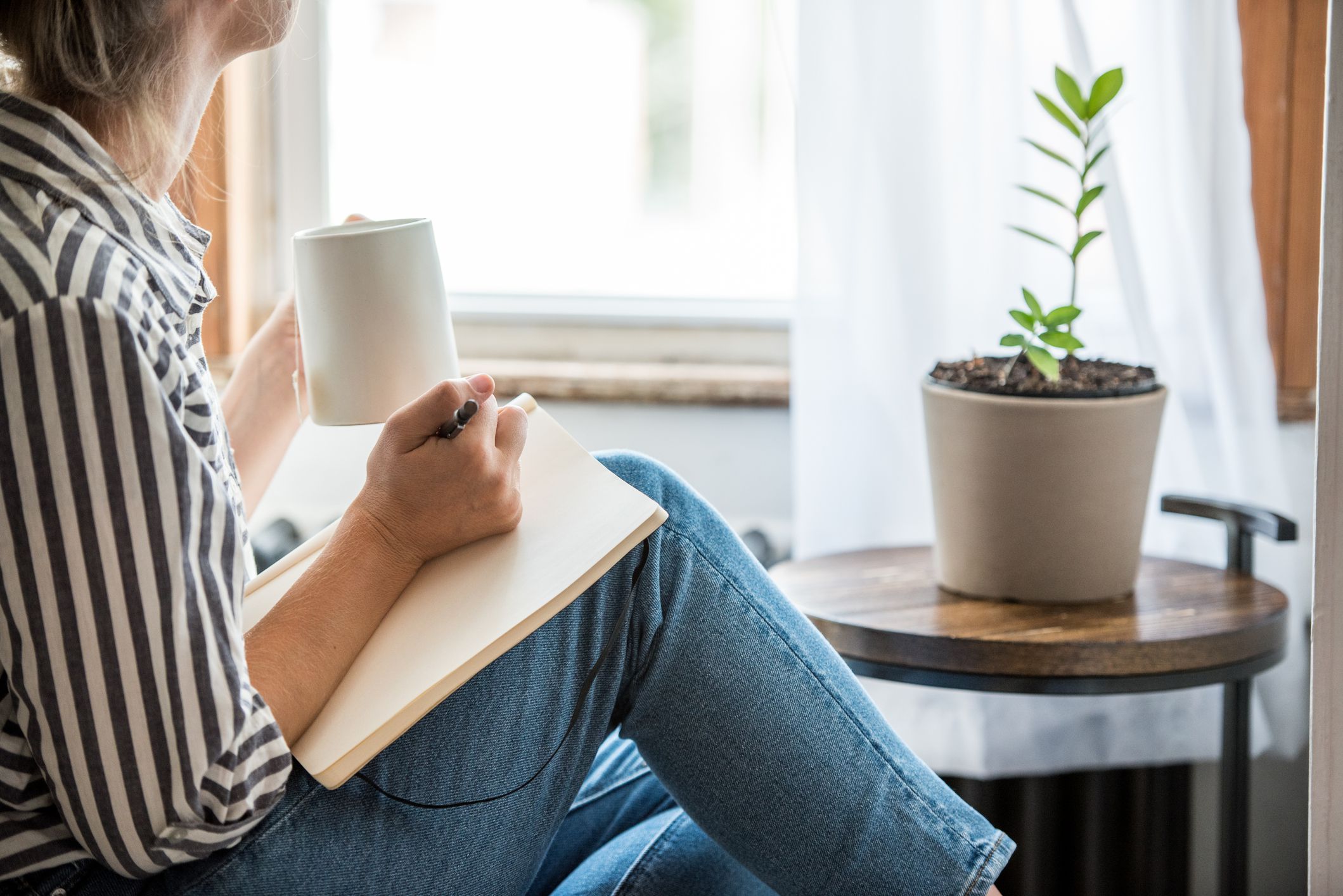 woman thinking while writing