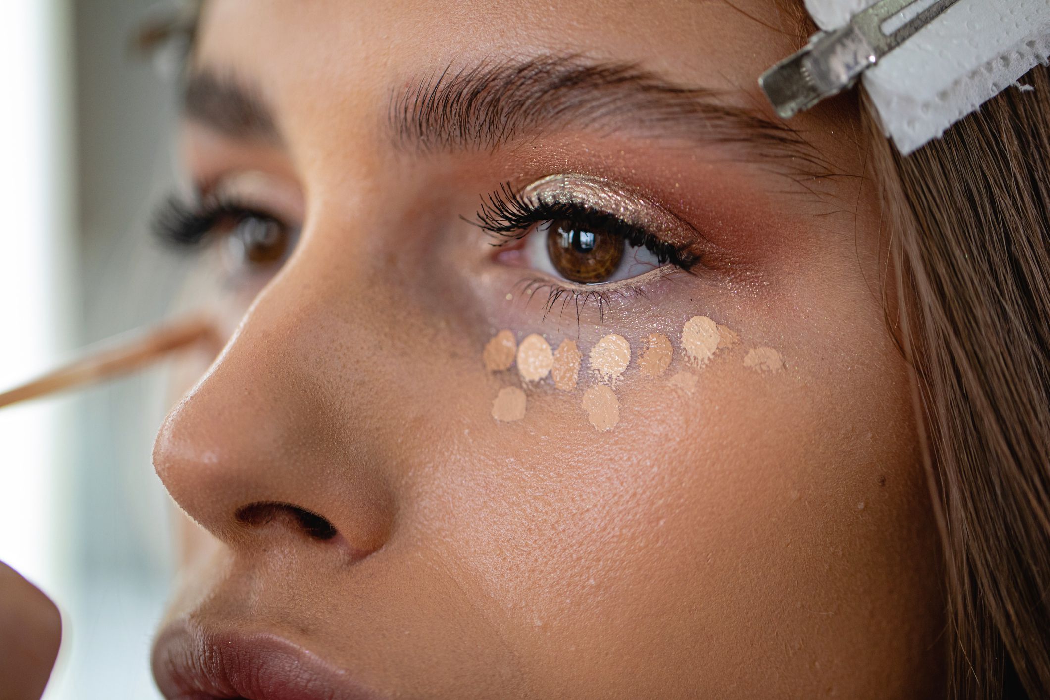 Professional model in a beauty salon enjoying getting makeup on