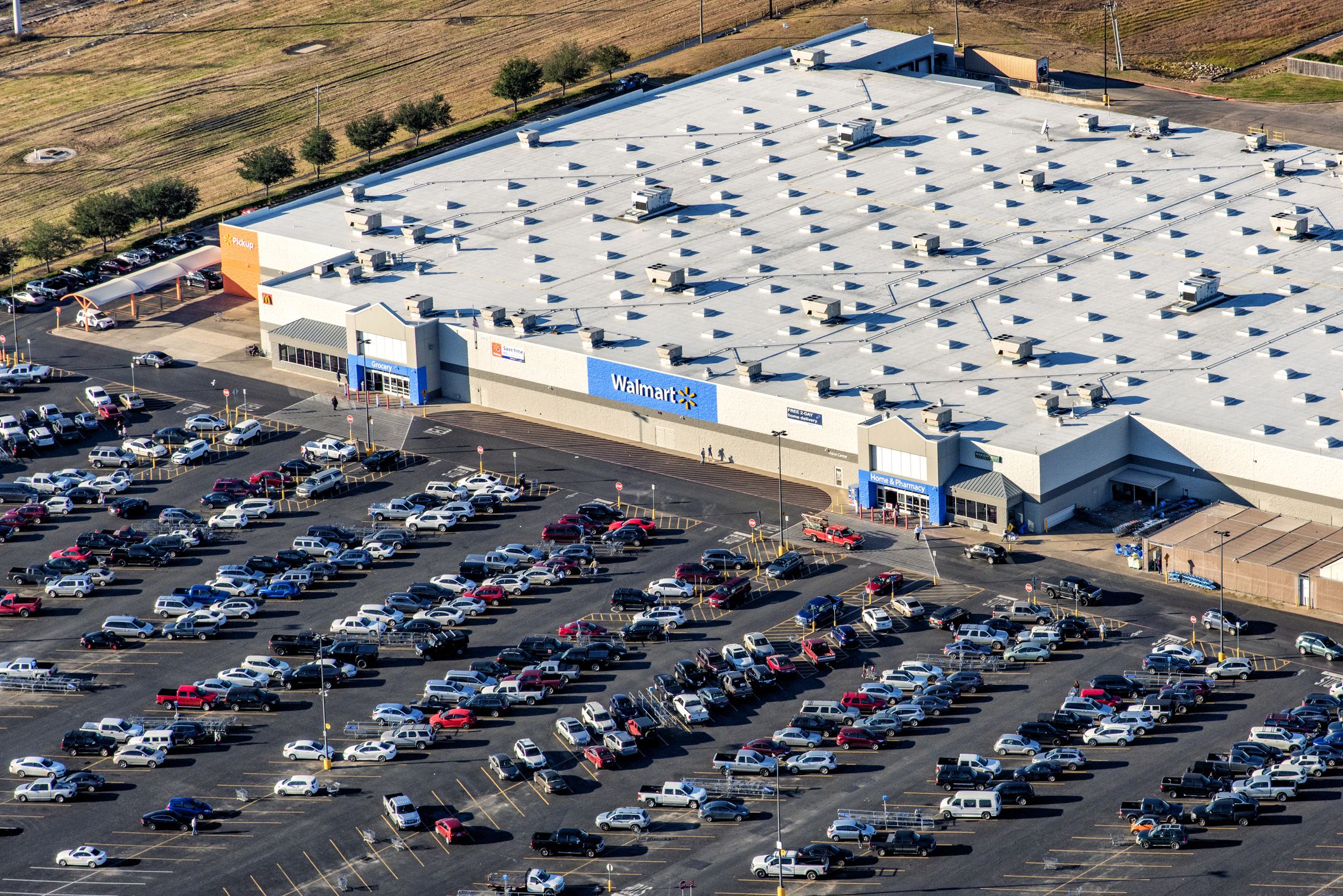 Houston, United States - December 10, 2018: Aerial view of a crowded Walmart supermarket and parking lot in the suburban Houston, Texas region from an altitude of about 1000 feet.