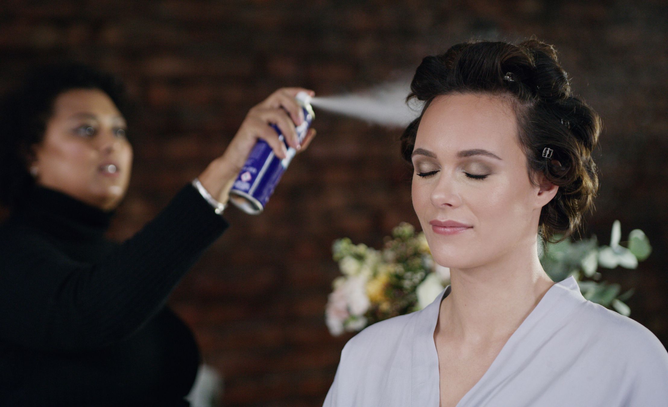 Cropped shot of a beautiful bride getting her hair done on her wedding day