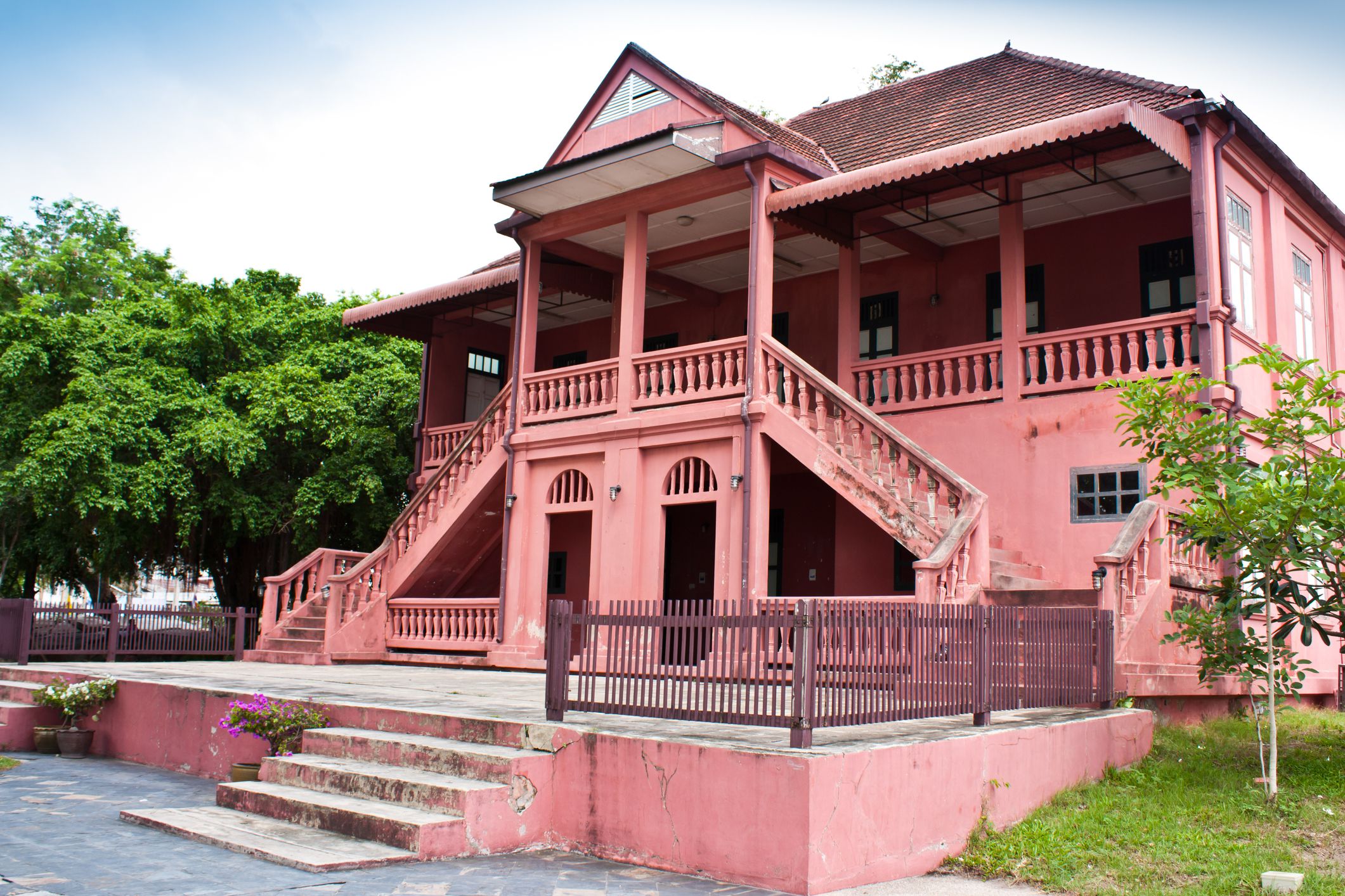 Old cement house. Painted with red, mixed with pink. Address City, Chonburi Thailand