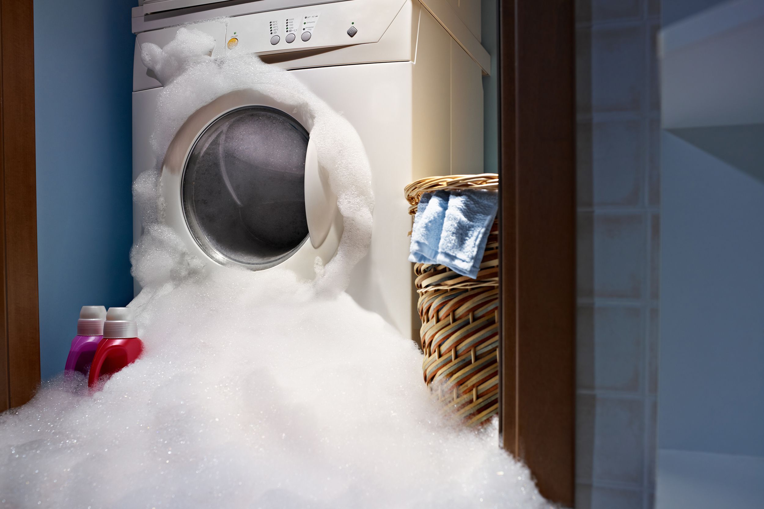 washing machine overflowing with soap and water