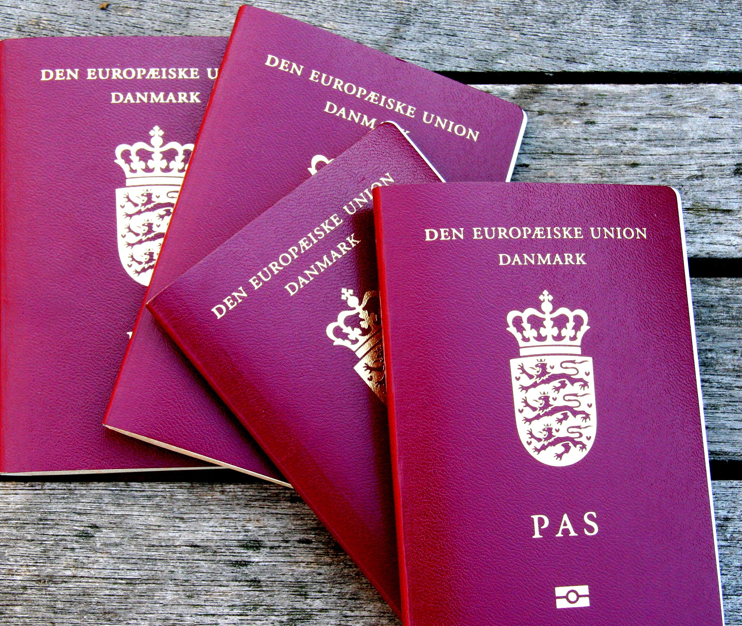 Four Danish Passports. Red European Community Passports.