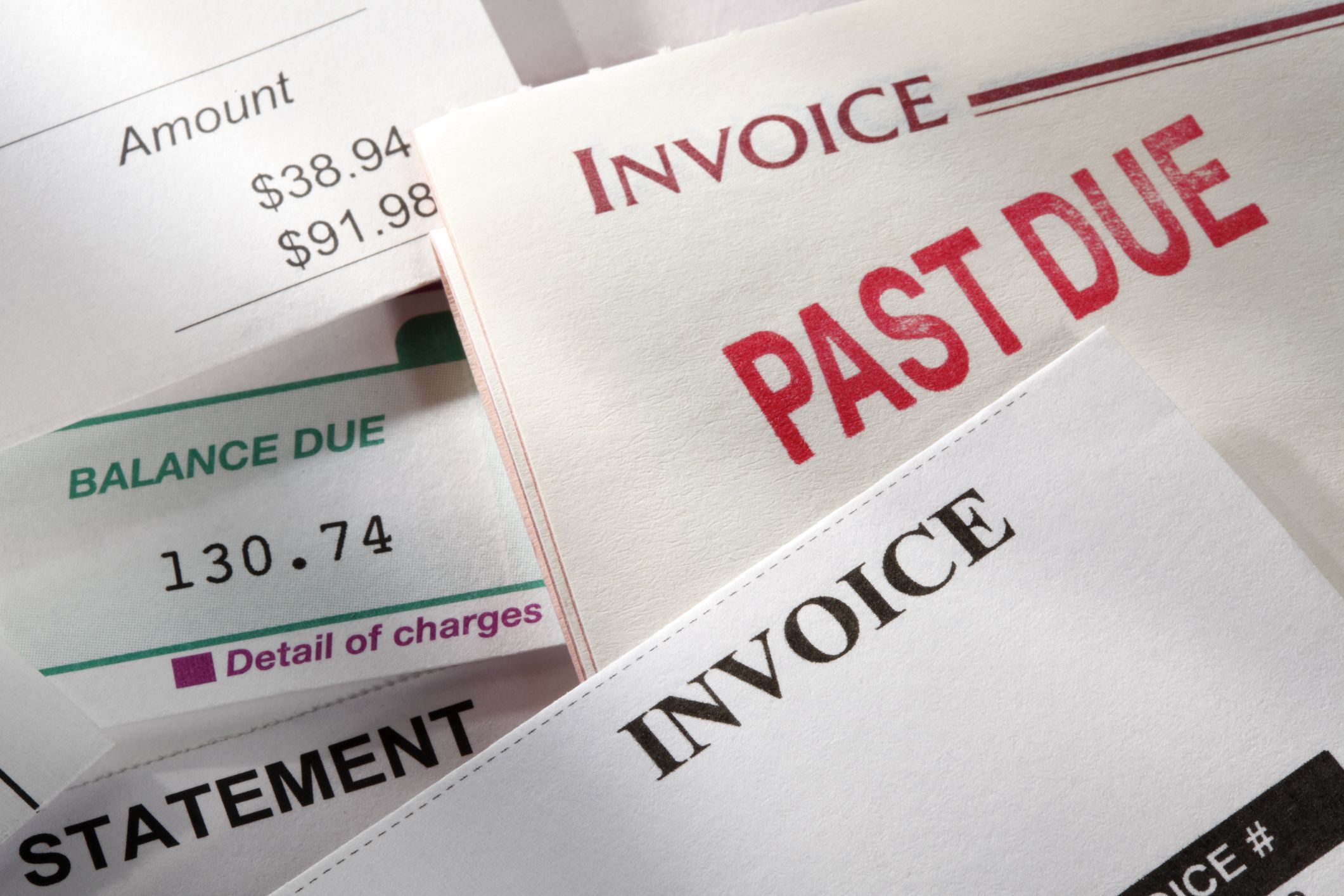 A random selection of bills or invoices with one of them stamped