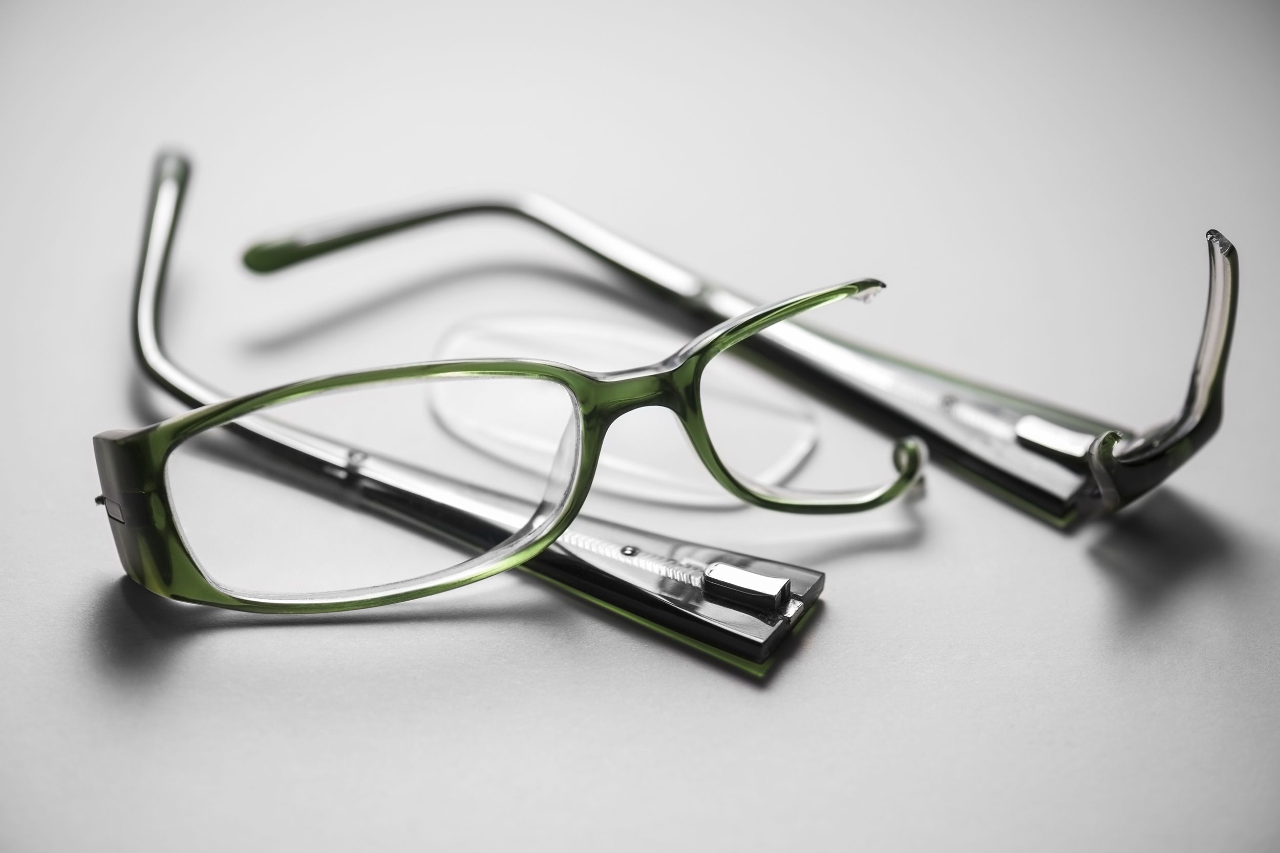 broken plastic spectacles on a white background