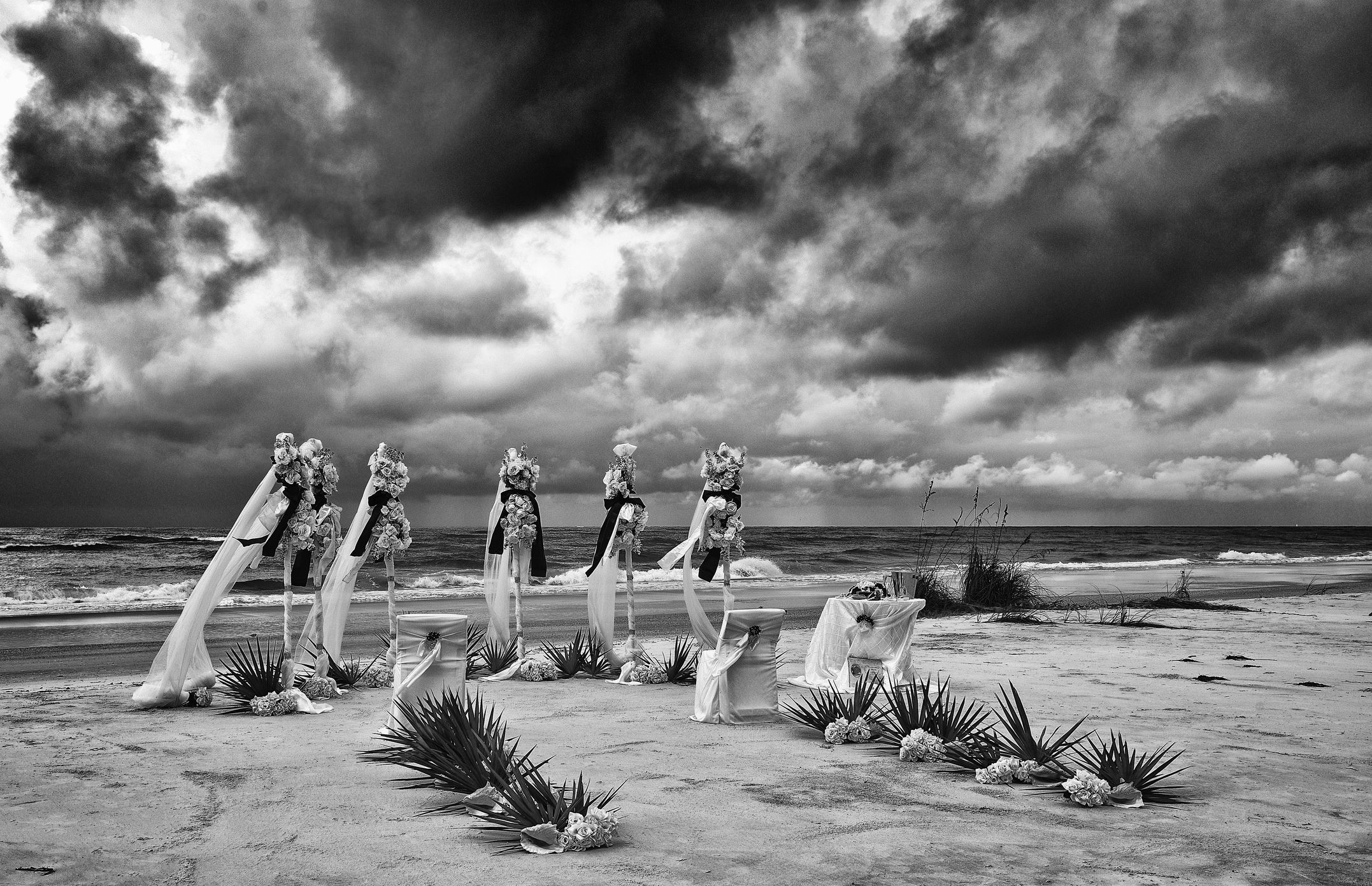 A Dramatic Image of a Wedding Set Up on a Stormy Beach. Filter applied for effect.