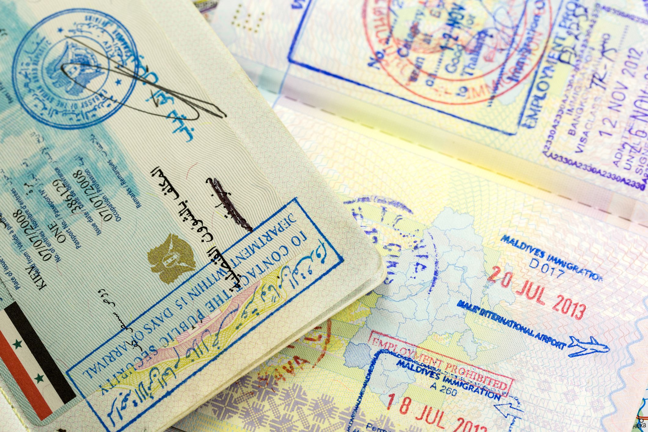 passports with syria, maldives and thailand visa stamps