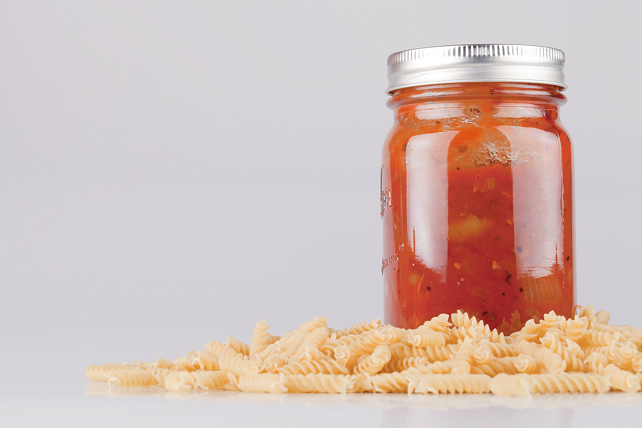 jar of pasta sauce with pasta