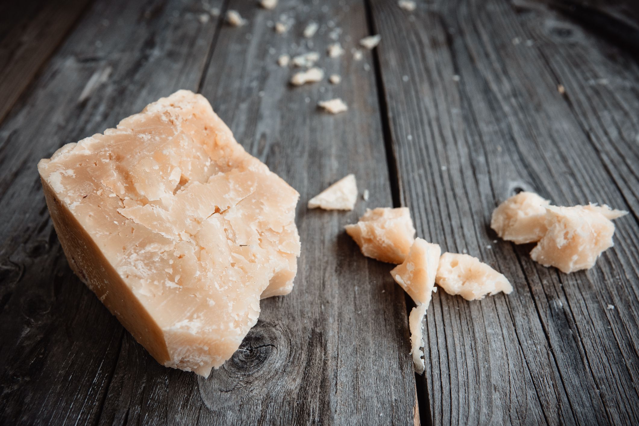 Italian hard cheese on the old wooden table