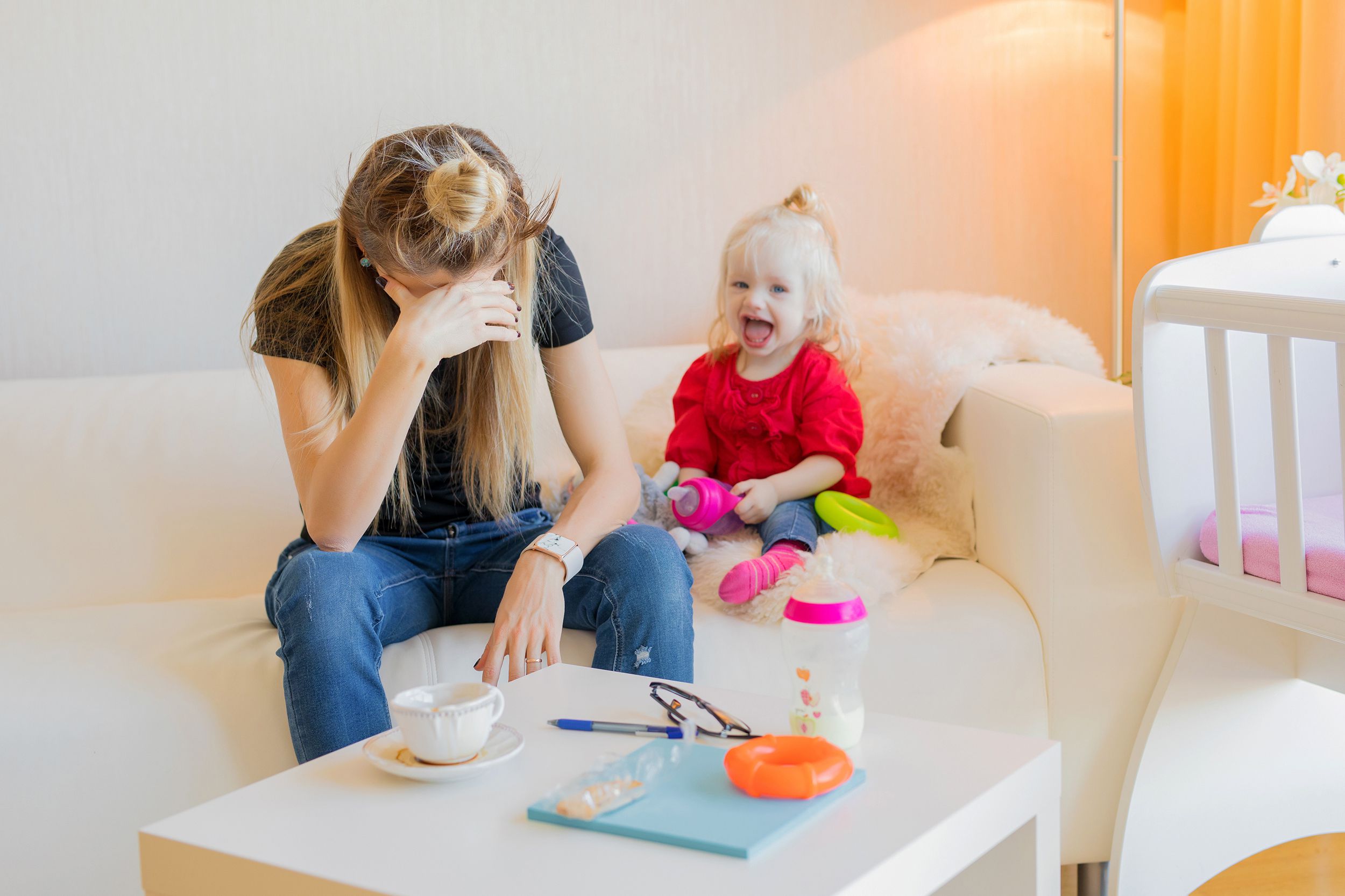 exhausted mother with little child