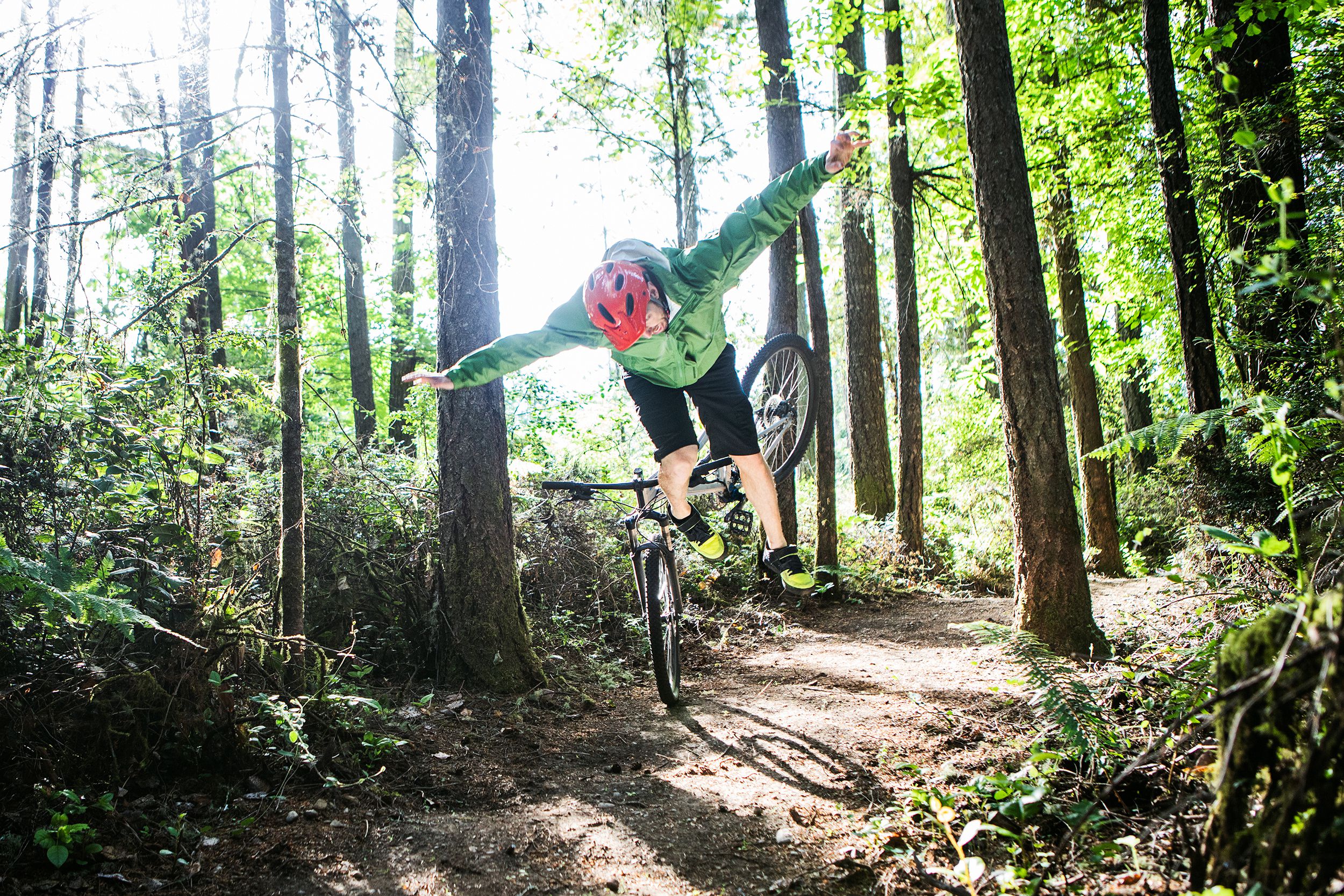 man crashing on mountain bike trail