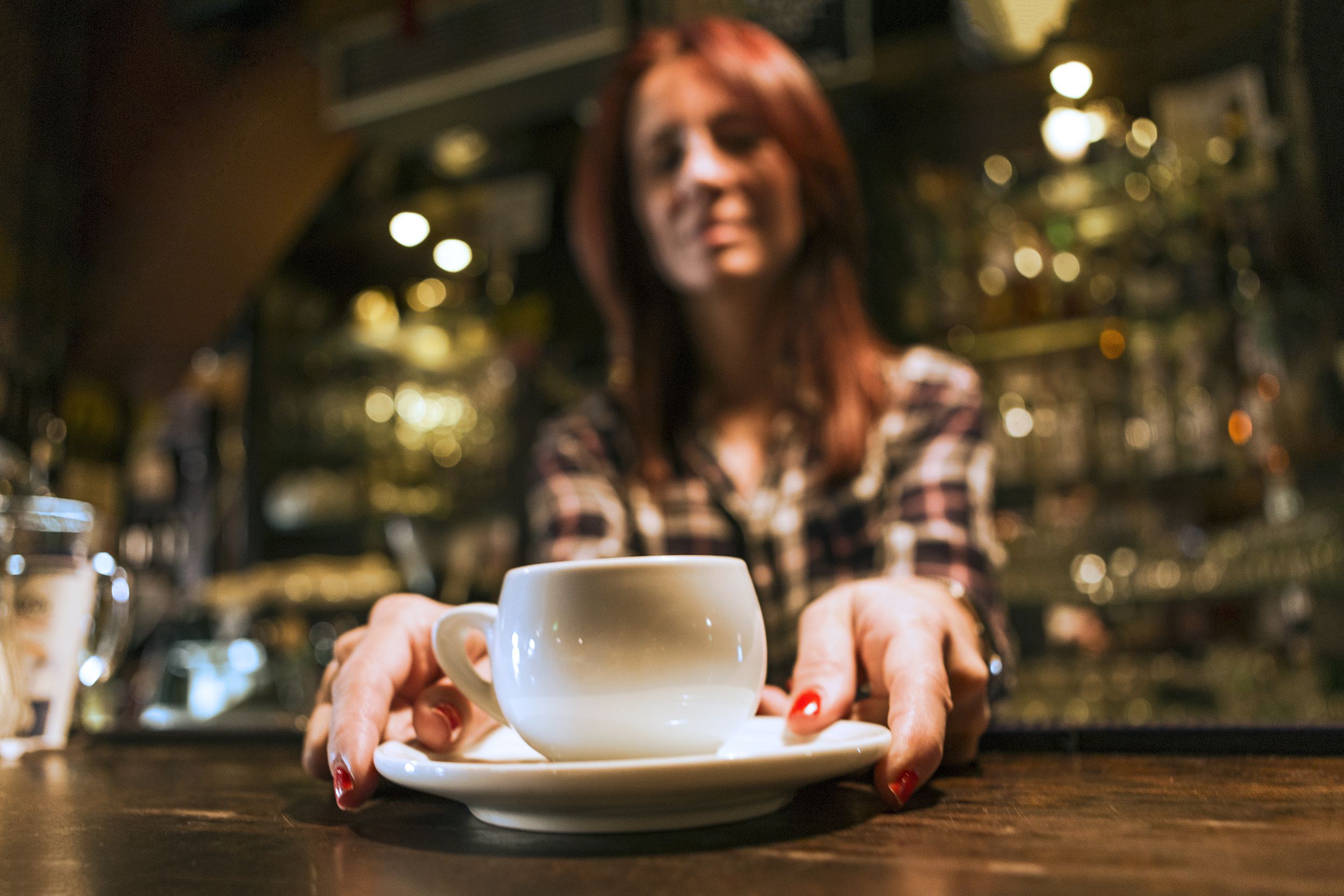 bartender serving coffee to customer