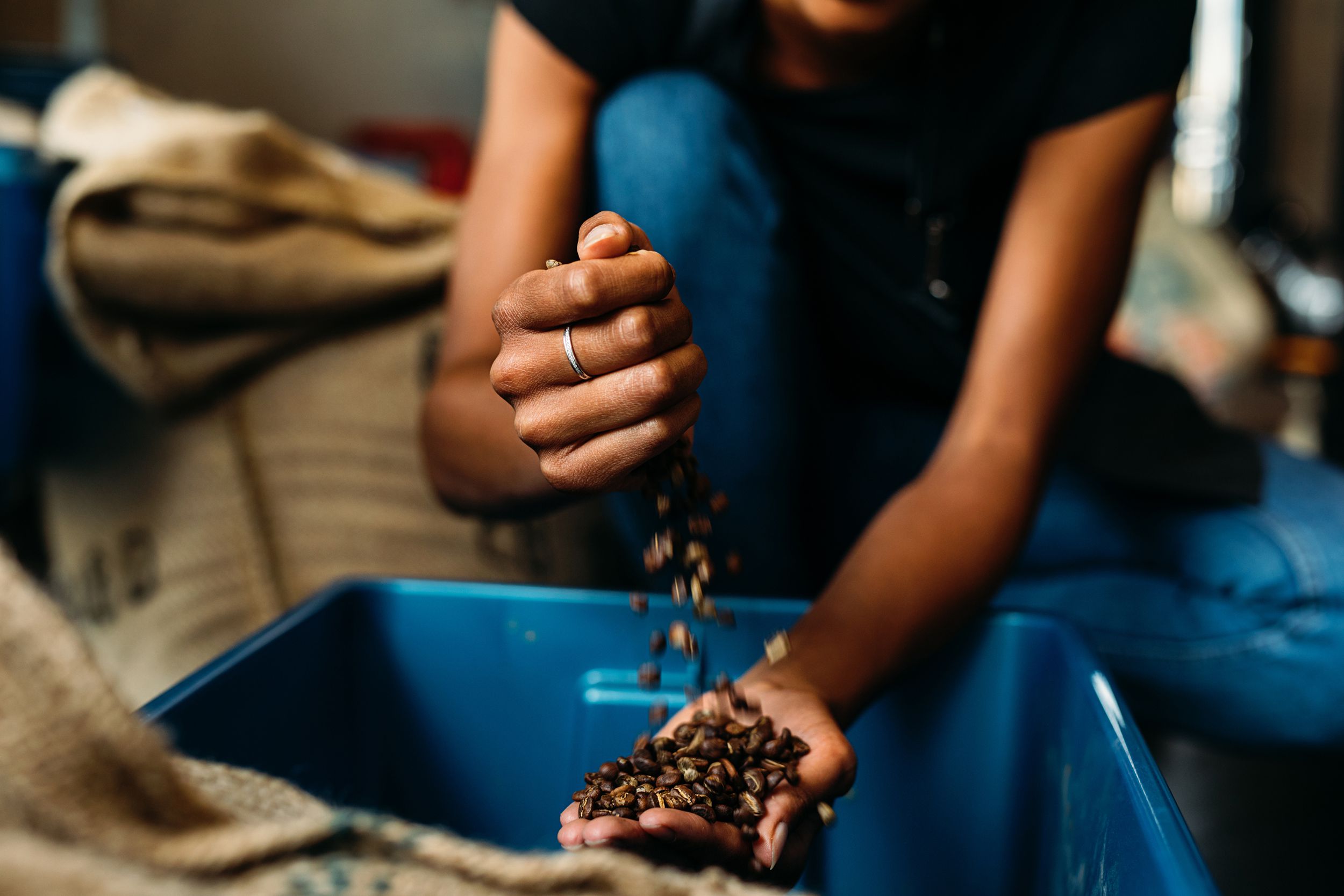 unrecognizable woman with coffee beans in her hands