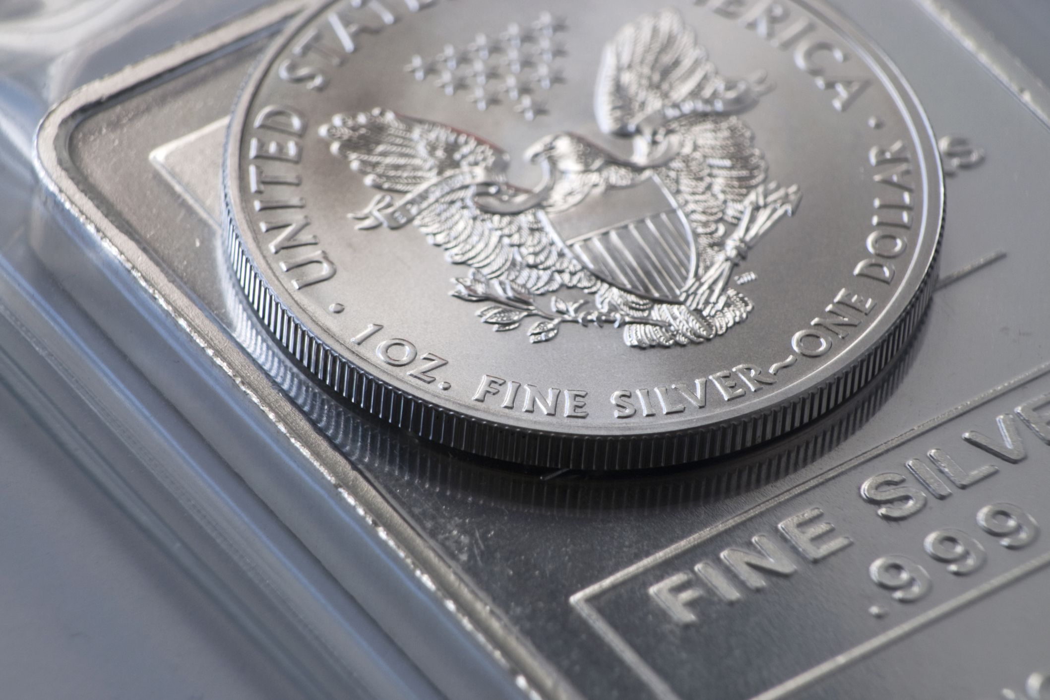 1 ounce us silver coin on US silver bullion with plastic packaging in the background