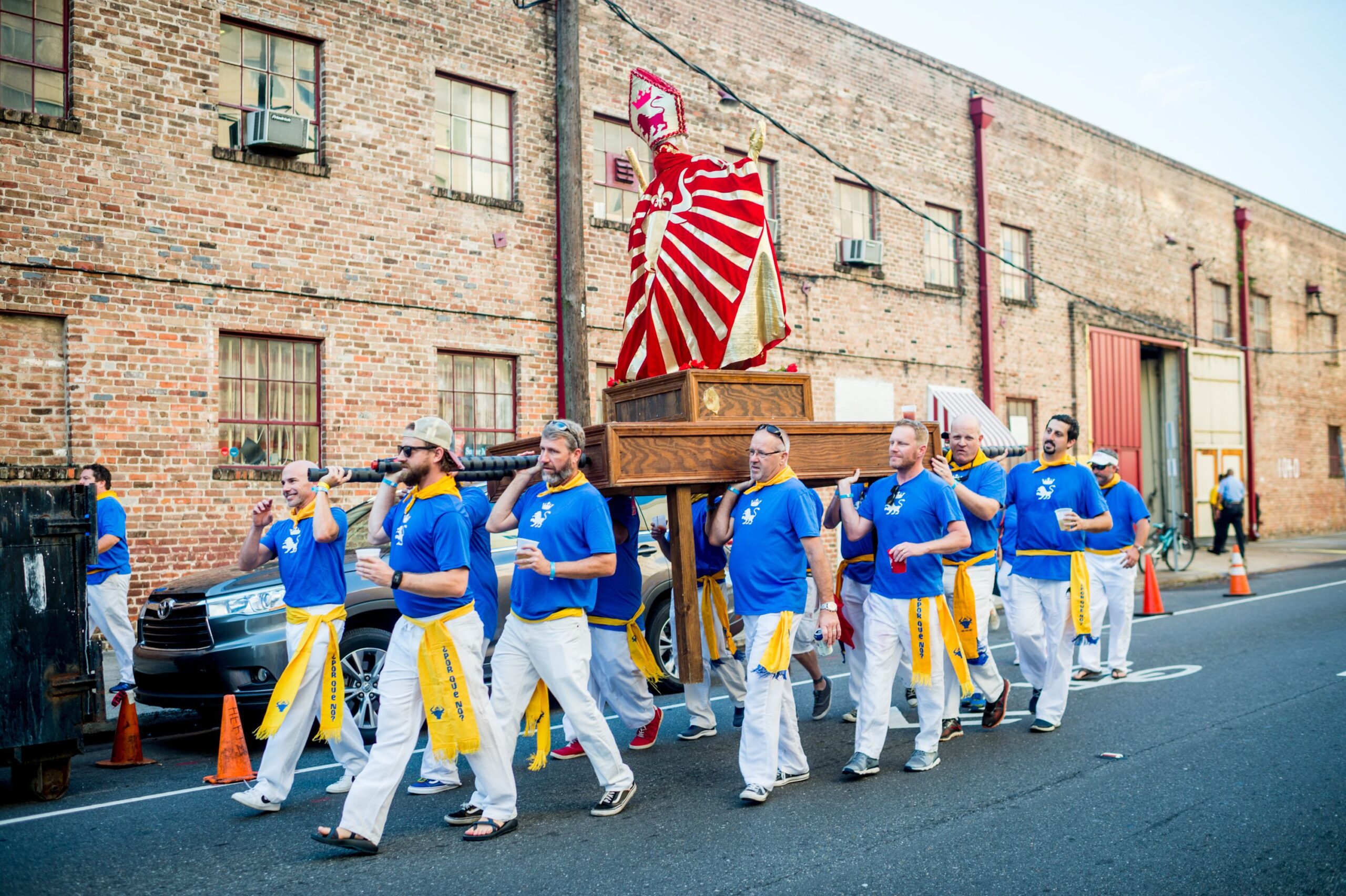 A statue of San Fermin, patron saint of the traditional Running of the Bulls festival in Pamplona, is carried to begin the New Orleans Running of the Bulls early in the morning in the Central Business District of New Orleans, La.