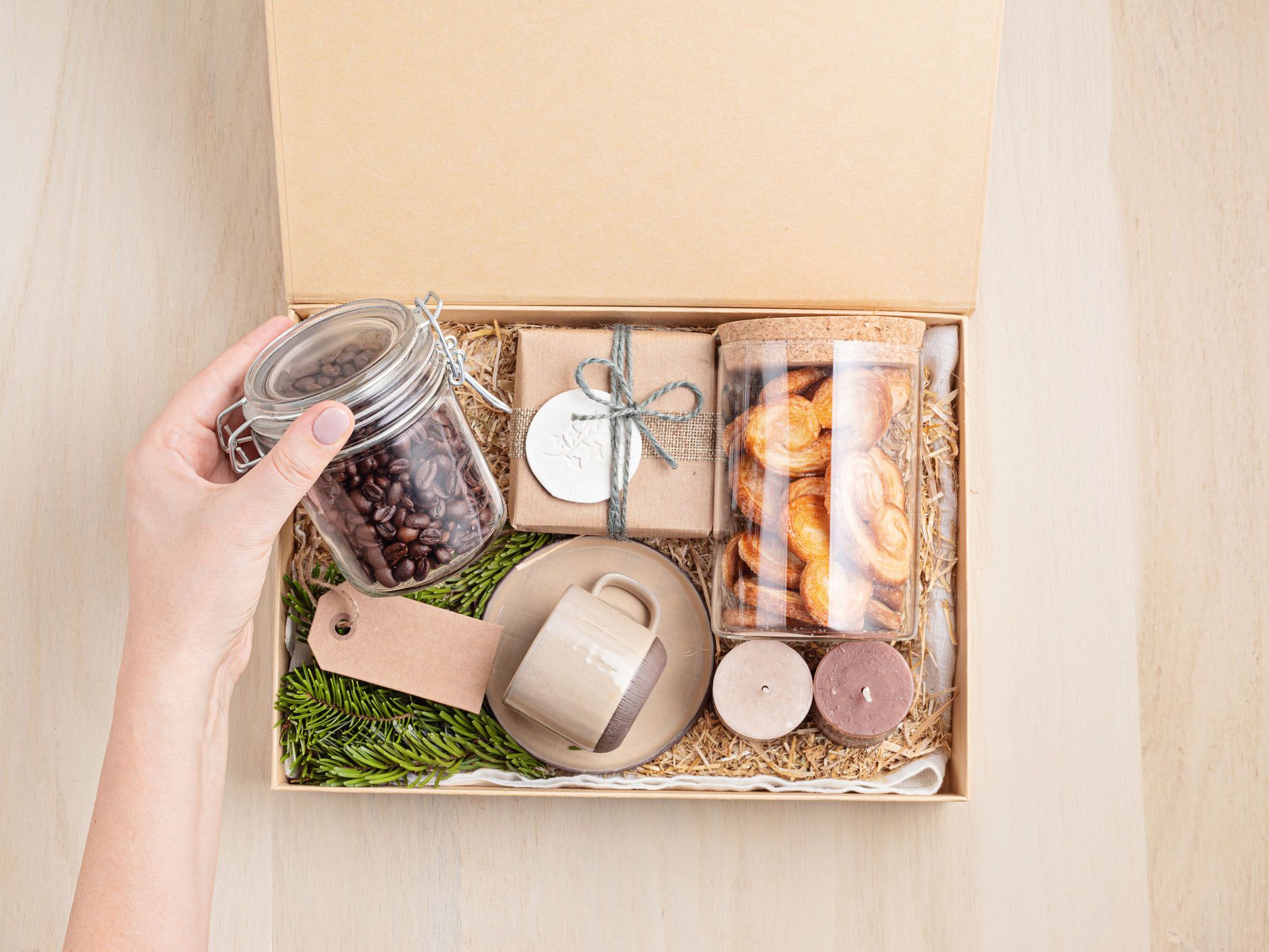Woman putting a jar of coffee beans into a square basket.