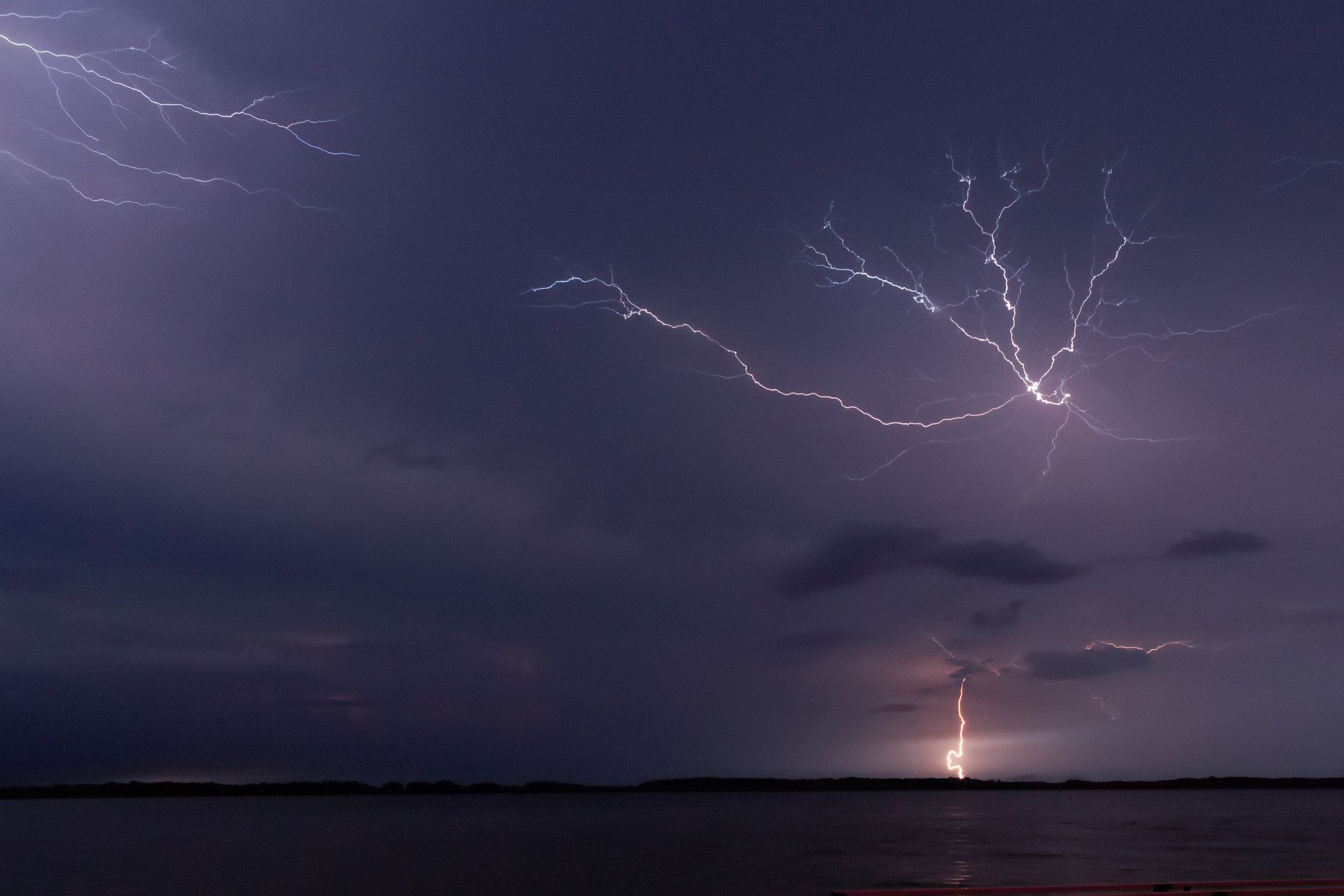 Lightning over lake at night