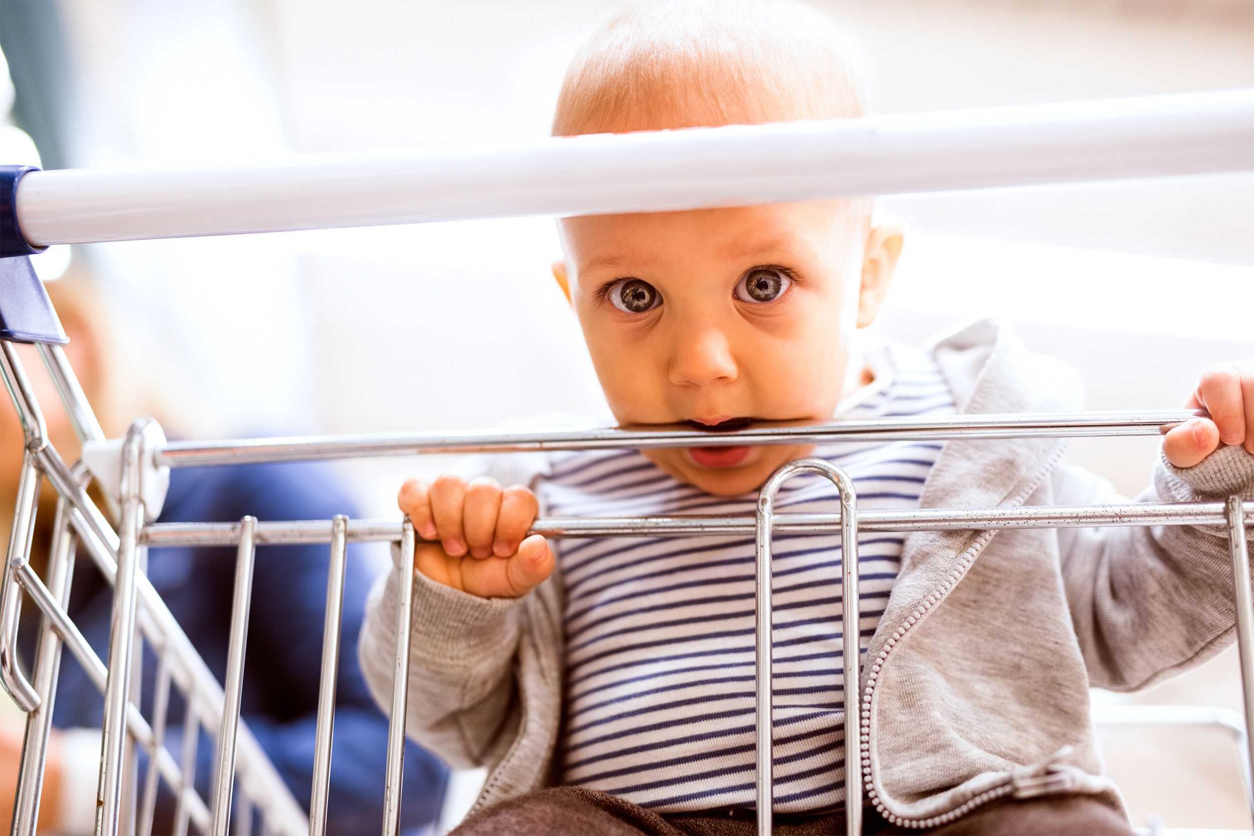 Baby putting mouth on shopping cart
