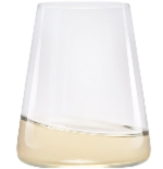 A clear, modern glass with a tilted base contains a small amount of pale white wine.