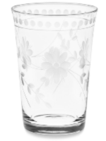 A clear glass tumbler with an etched floral pattern and a row of frosted dots near the rim.