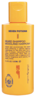 A yellow bottle of Seven Potions Beard Shampoo Woodland Harmony with black text and a brief product description printed on the front.