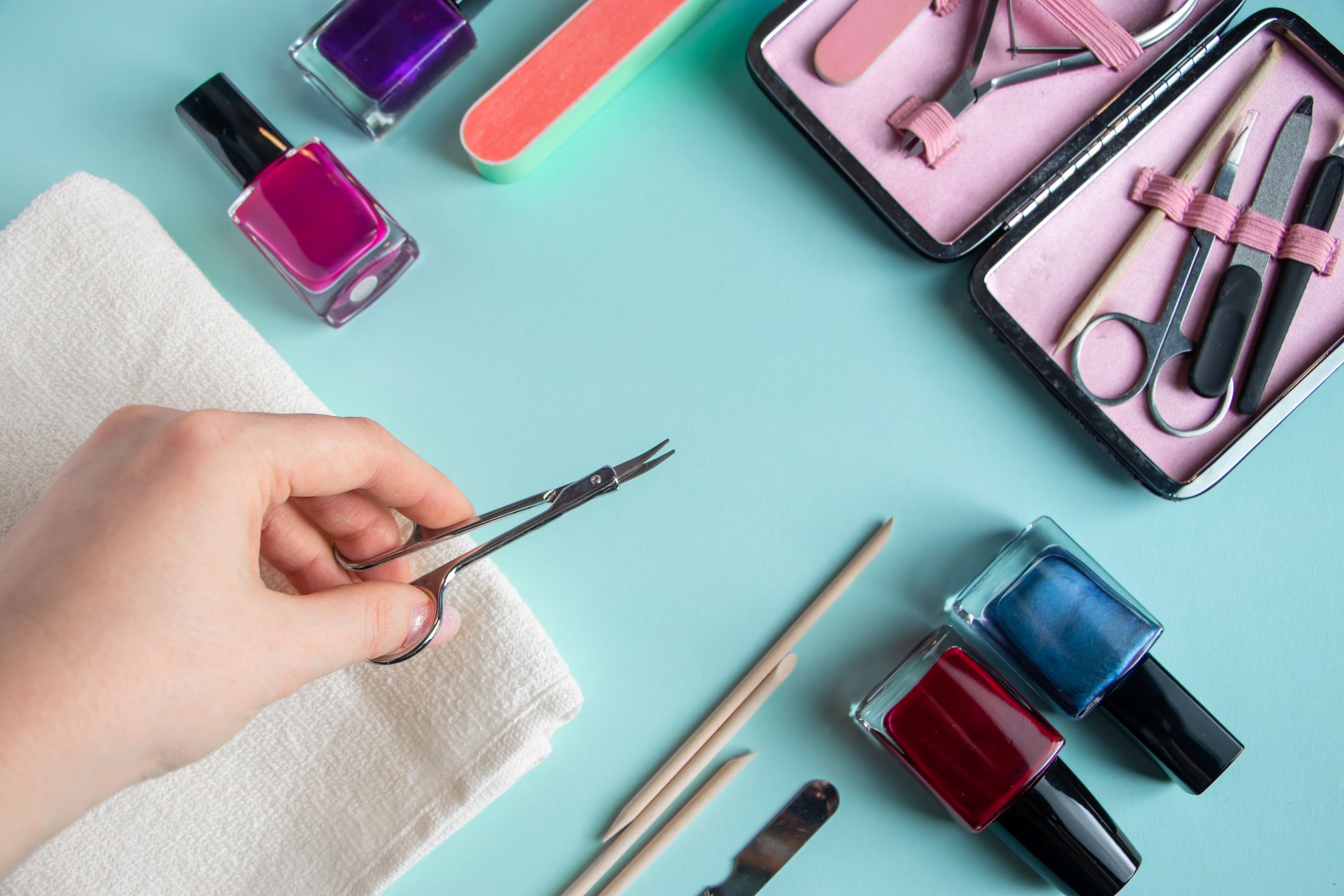 A set of tools for hand care on a light blue background.