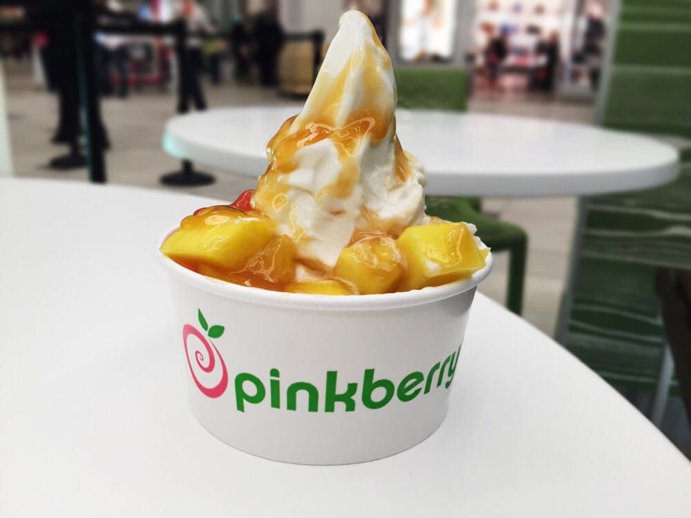 Pinkberry frozen yogurt with mango, mochi, strawberry boba, and caramel