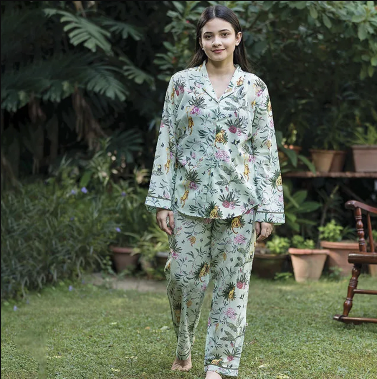 A woman wearing Uncommon Goods Secret Garden Pajama Set in an outdoors setting