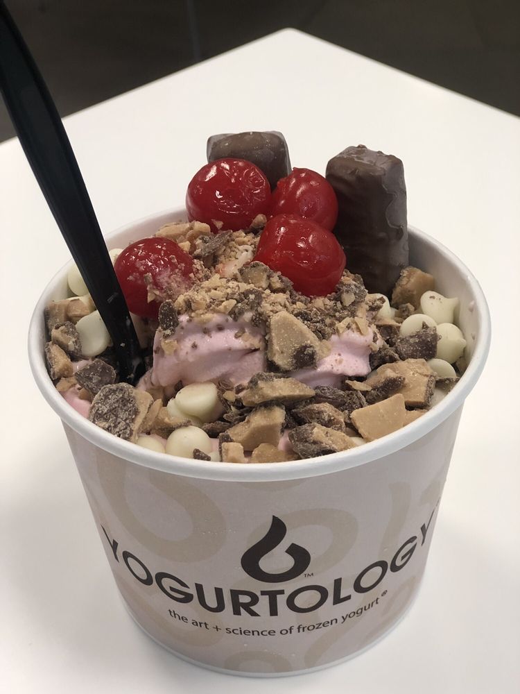 Strawberry Milkshake & Cookies n Cream with cherries, Twix, crushed Heath Bat and white chocolate chips from Yogurtology