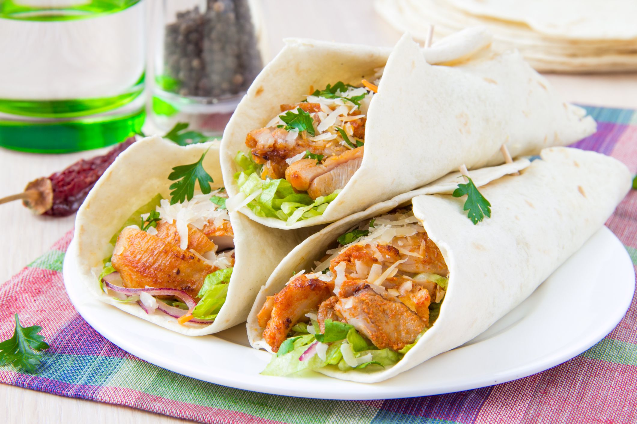 Wrapped in a tortilla roll with spicy fried chicken and vegetables salad, tasty Mexican dish