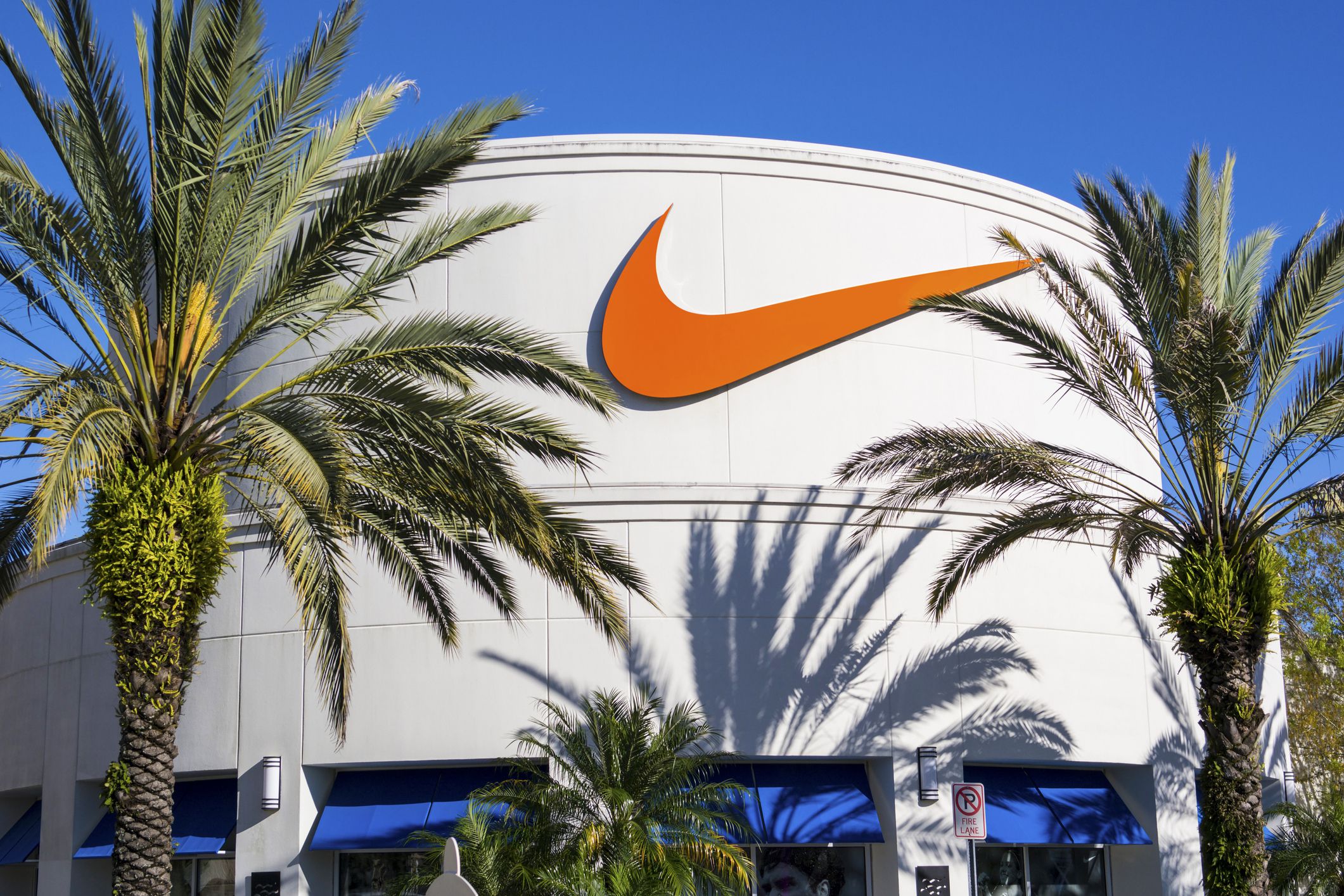 Orlando, USA - February 15, 2014: Photo of facade of Nike Store at Orlando Premium Outlets, located at 8200 Vineland Avenue, Orlando. It was a sunny and clear day. Palm trees in front the store.