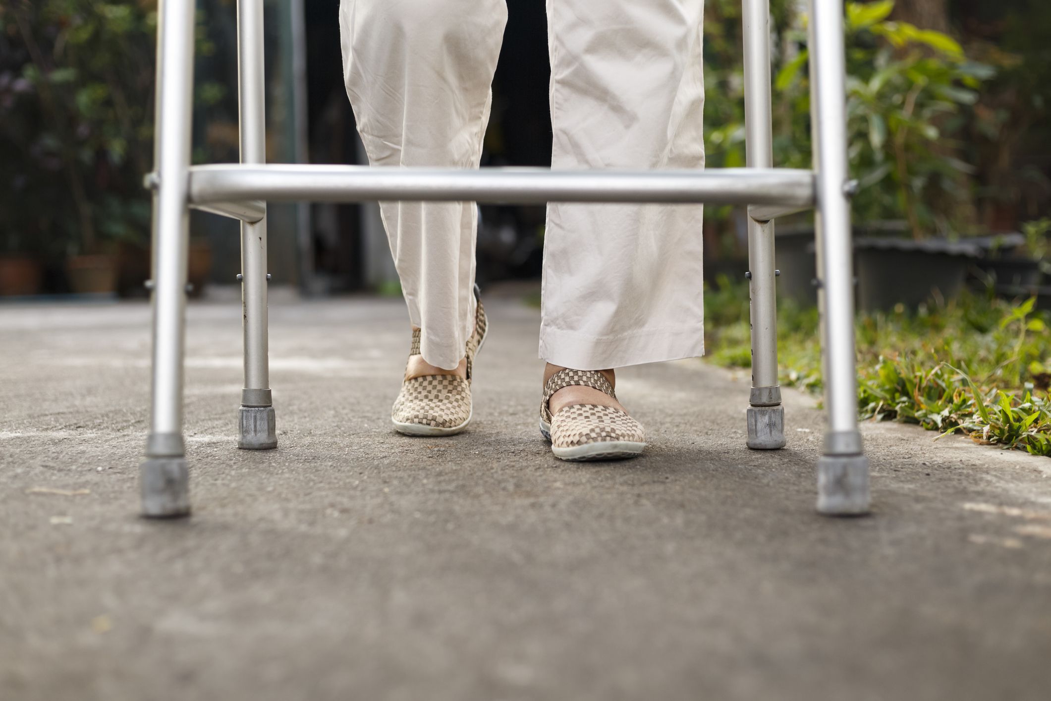 senior woman using a walker at home.