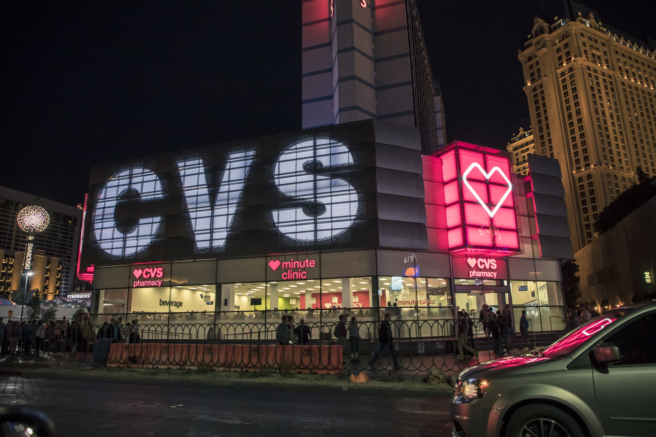 An editorial stock photo of the CVS store front on Las Vegas strip. Cars and People can be seen traveling up and down the famous strip.