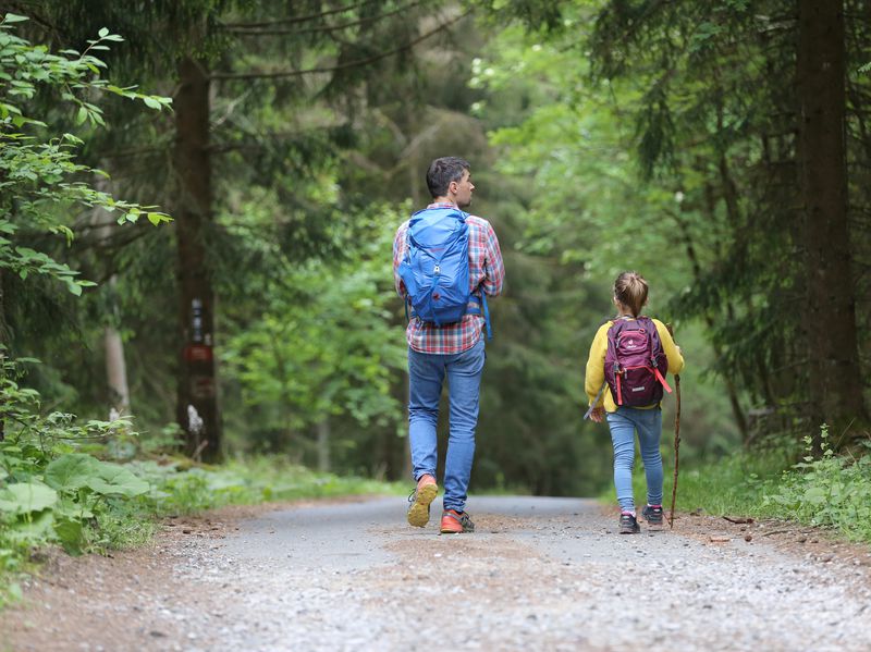 father and daughter out in the forest