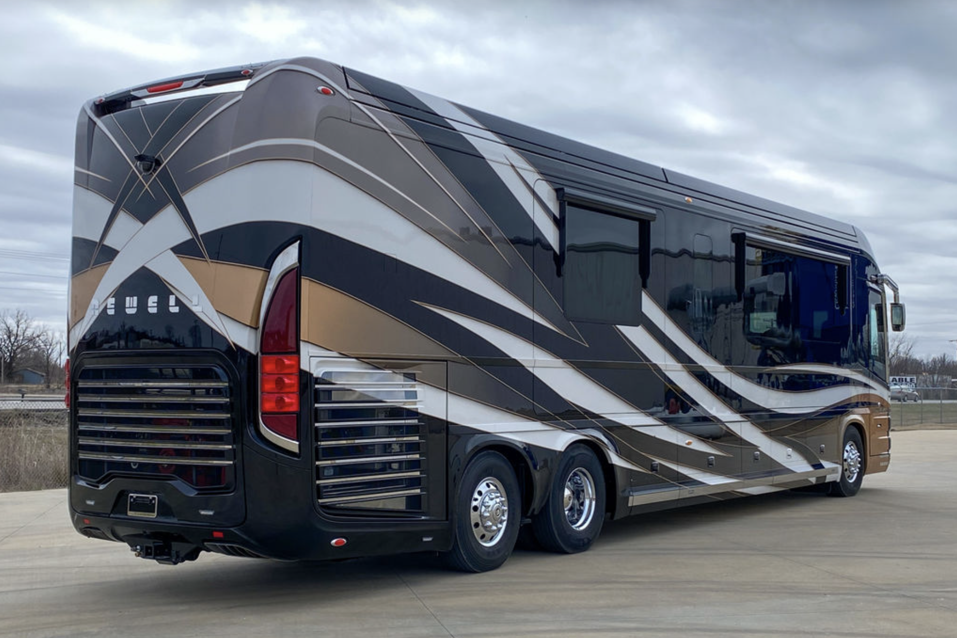 Exterior of Newell Coach p50, side and back, on a parking lot, clouded sky in the background during winter