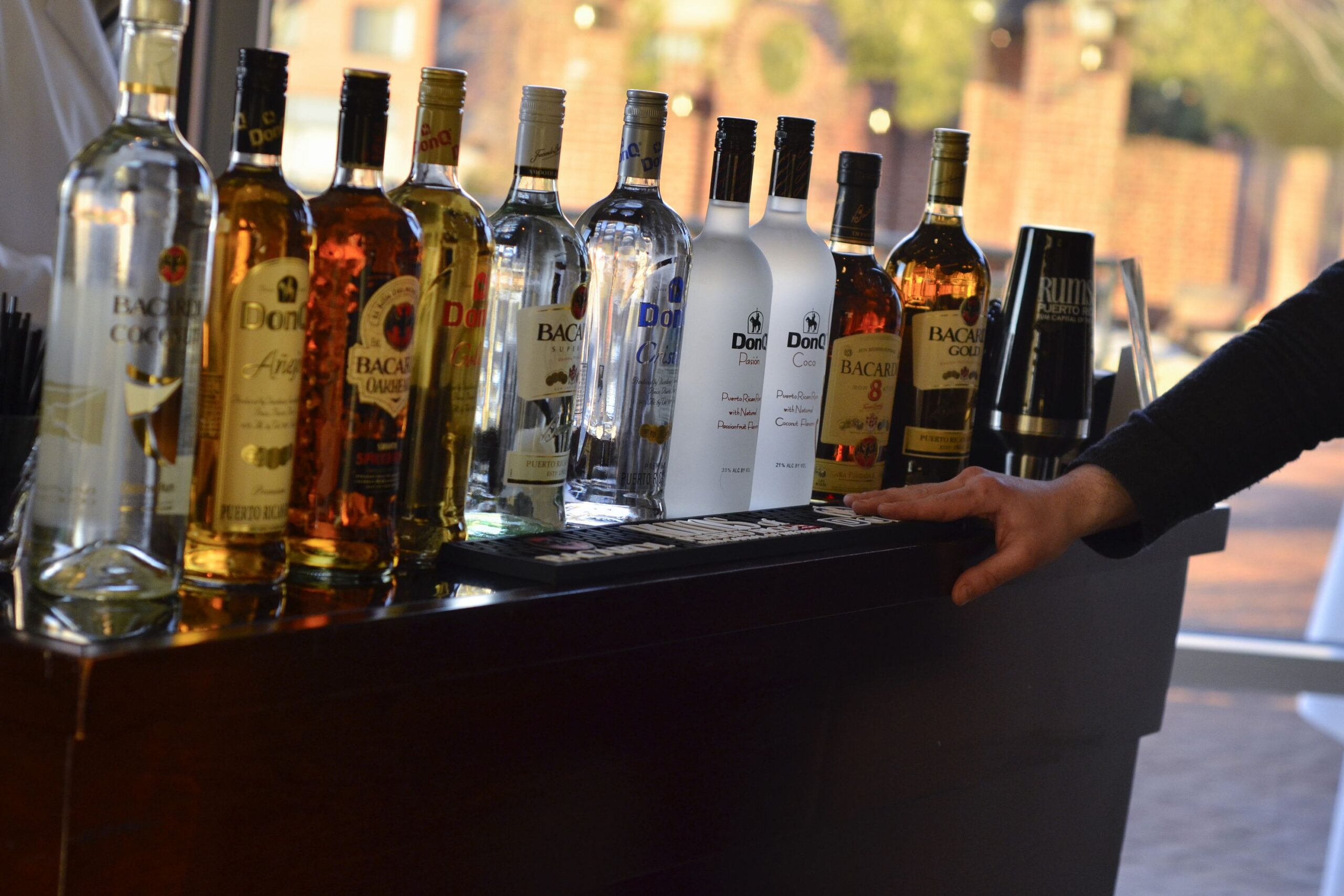 puerto rican rums lined up at bar including bacardi and donq