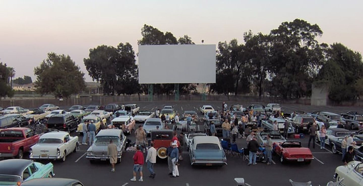 Rows of classic cars parked at Mission Tiki Drive-In Theatre.