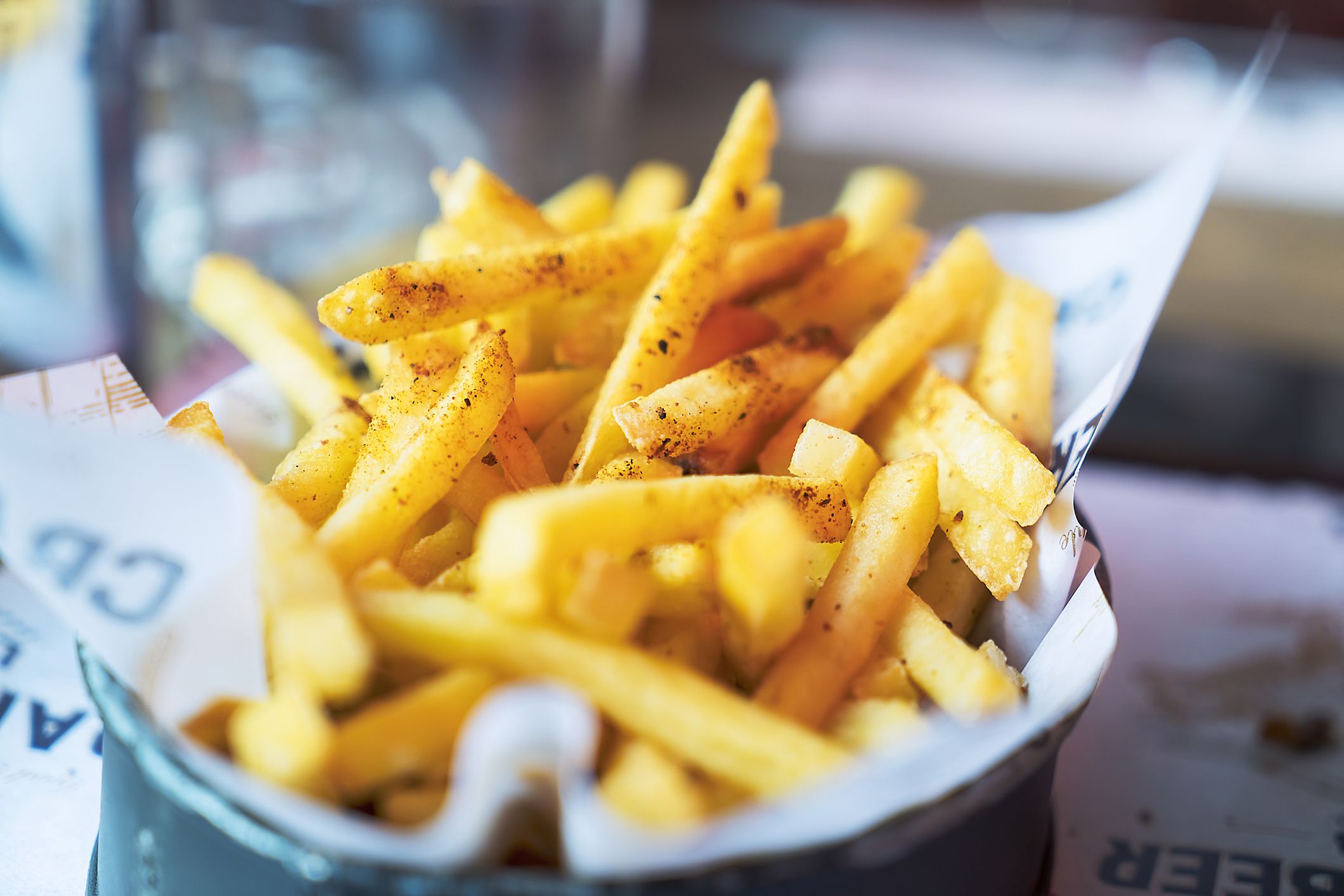 Close-up of French Fries on table in pub