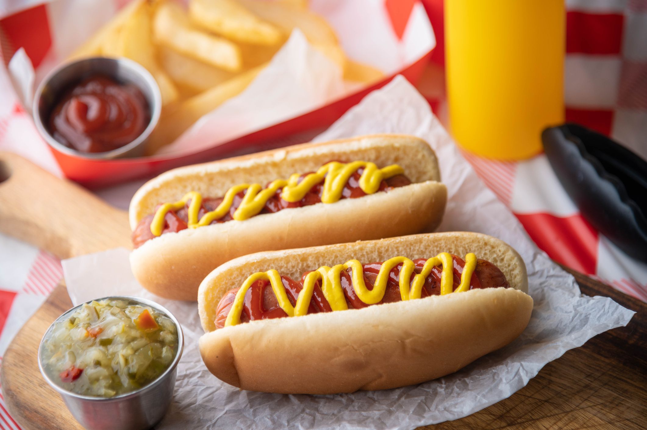 hot dog with french fries on red check table clothes