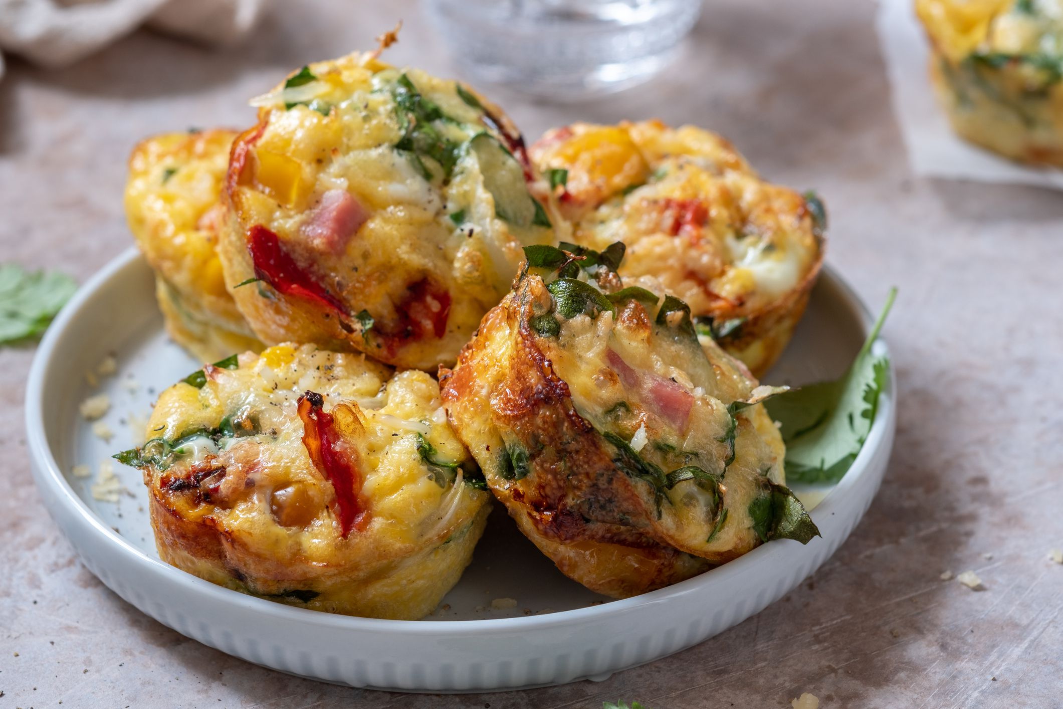 Delicious egg muffins with ham, cheese, spinach and vegetables