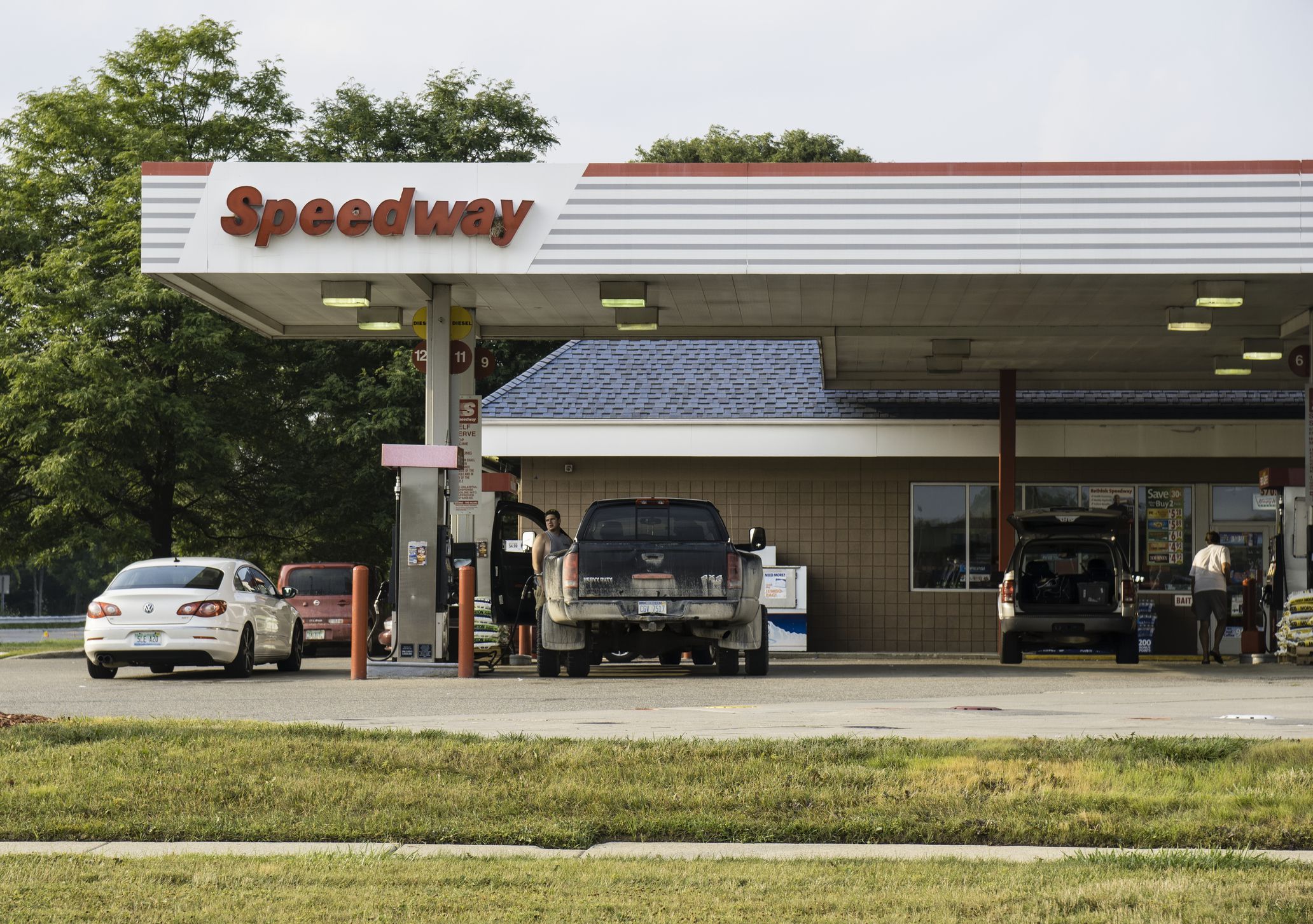 Shelby Township, Michigan, USA - August 3, 2014: People at a Speedway gas station. Speedway is a chain of gas stations and convenience stores with ca. 1,500 locations in the USA.