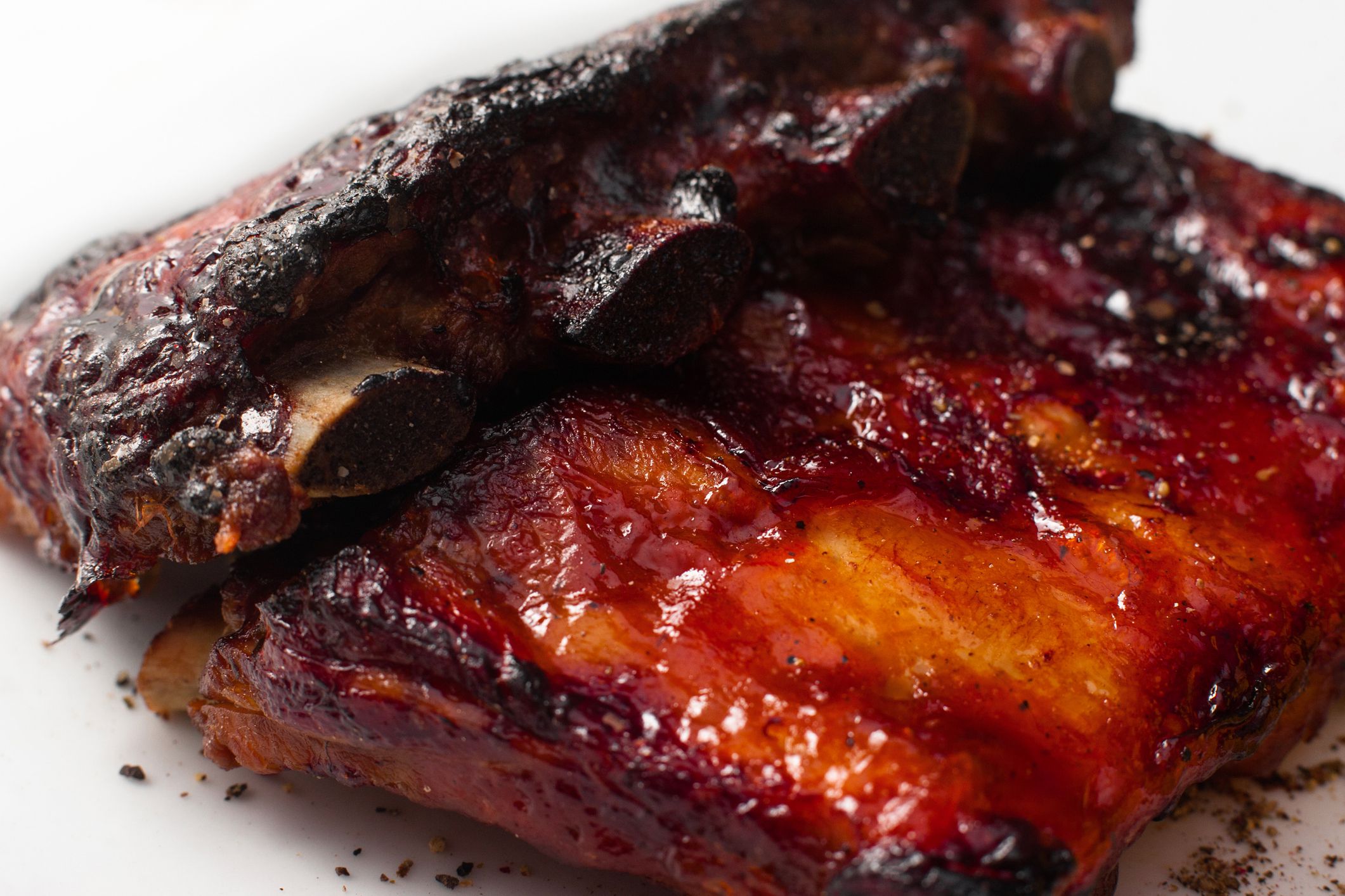 Hot appetizing bbq ribs closeup. Just prepared pork meat. American traditional cuisine, homemade cuisine, junk food concept