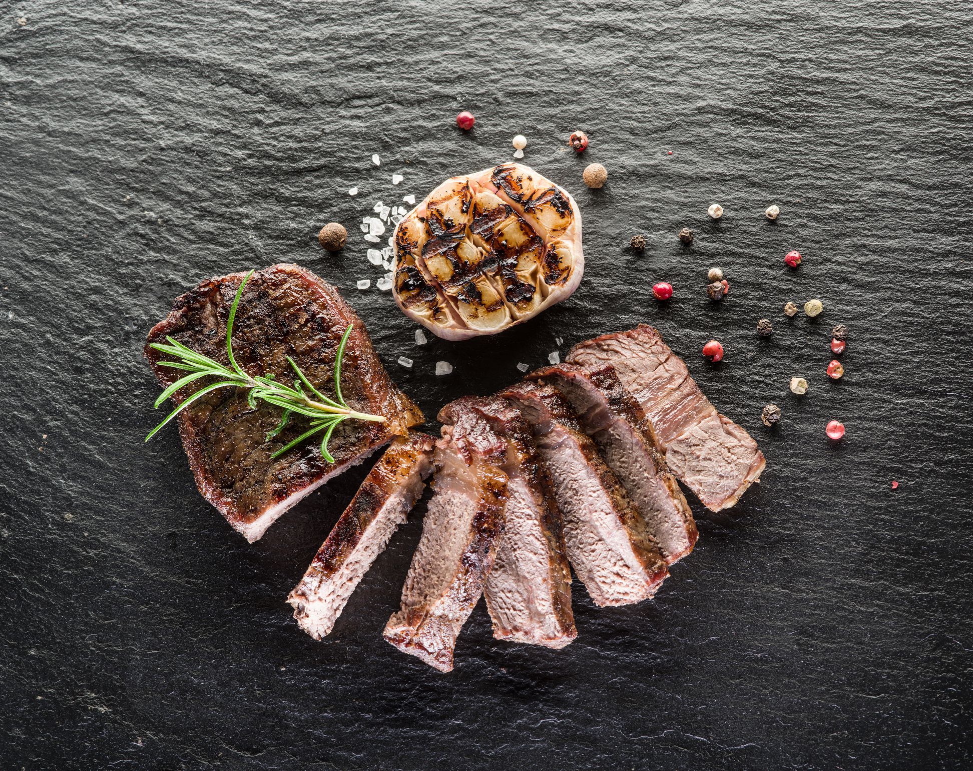 Steak Ribeye with spices on the graphite board.