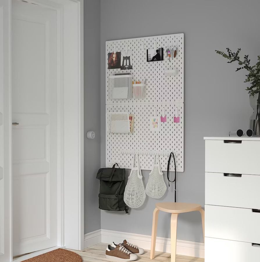 Skådis Pegboard Combination organized with backpacks, notebooks, pens, and more